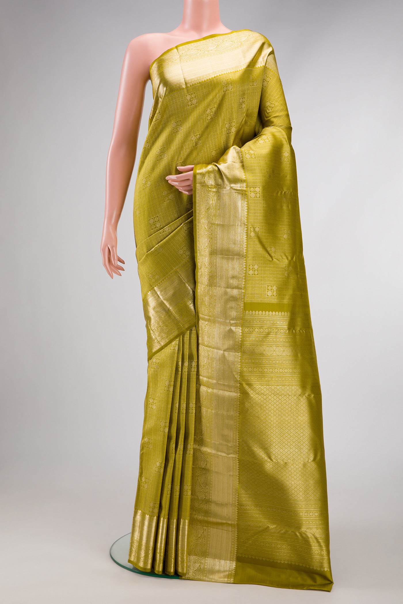 Mehandi Green Dual Tone Kanchipuram Silk Saree with Zari Brocade on the body and Zari Border.  displayed on a mannequin