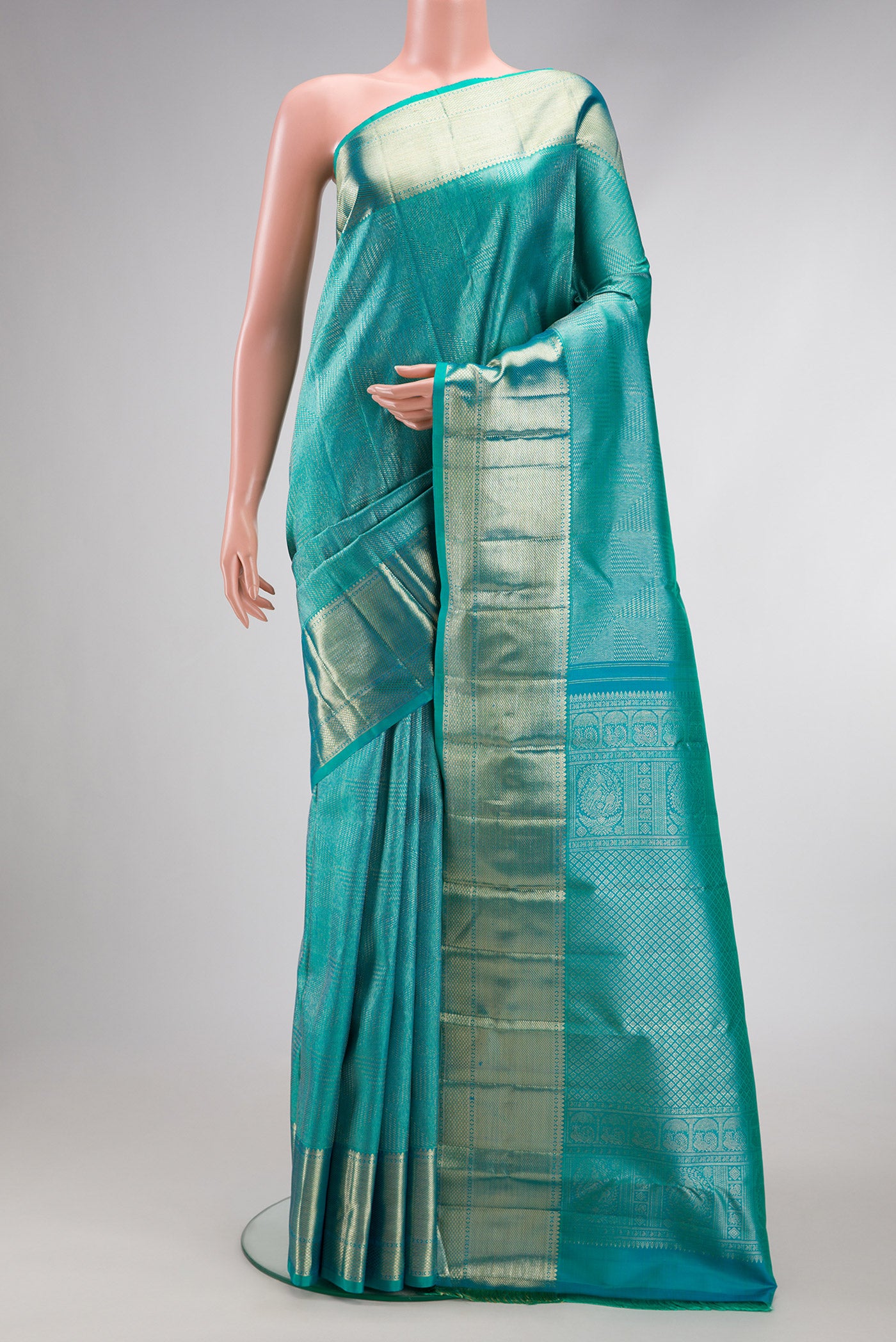 Turquoise Dual Tone Kanchipuram Silk Saree with Zari Brocade on the body and Zari Border.  displayed on a mannequin