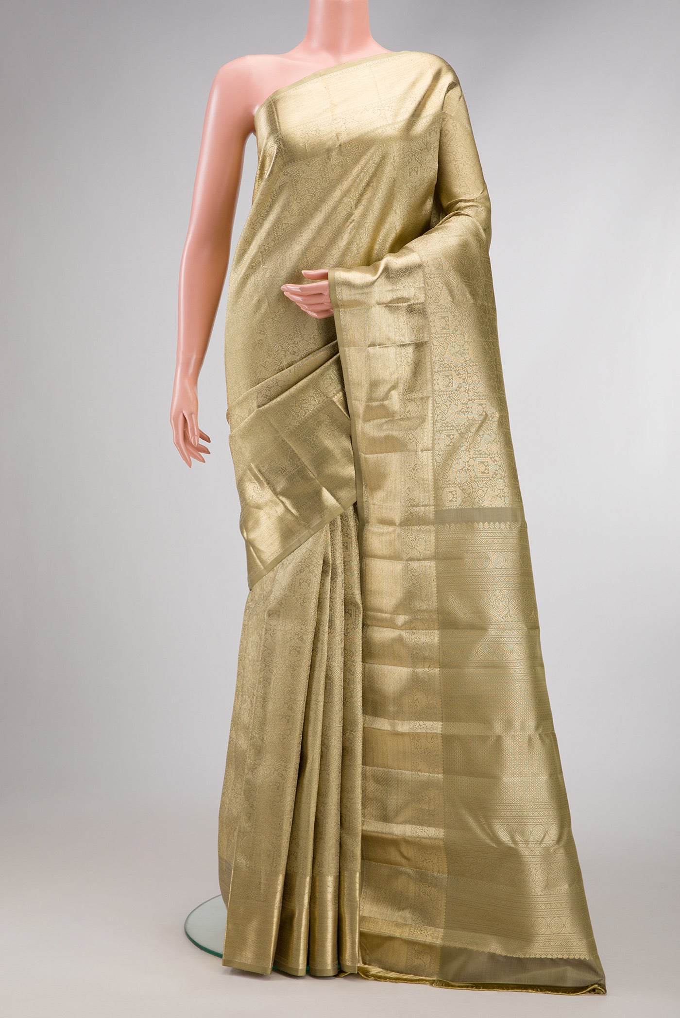 Beige Dual Tone Kanchipuram Silk Saree with Zari Brocade on the body and Zari Border.  displayed on a mannequin