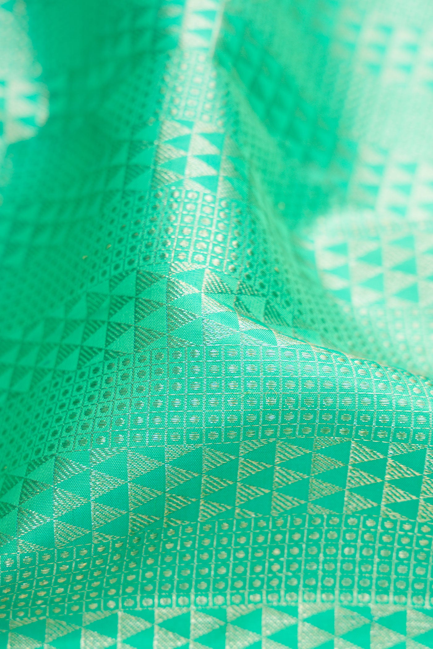 Close up of Sea Green Dual Tone Kanchipuram Silk Saree with Zari Brocade on the body and Zari Border.  displaying folds