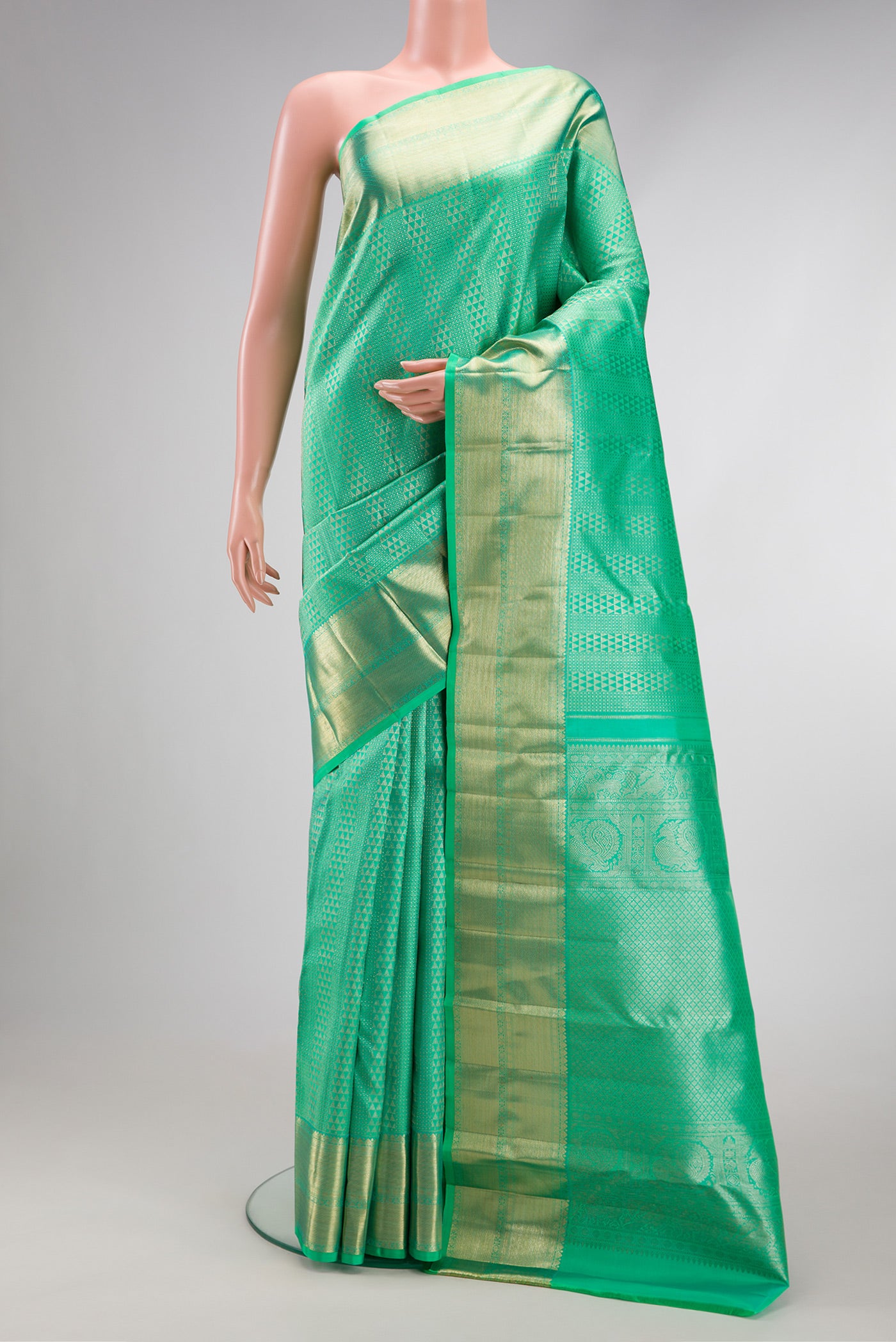 Sea Green Dual Tone Kanchipuram Silk Saree with Zari Brocade on the body and Zari Border.  displayed on a mannequin