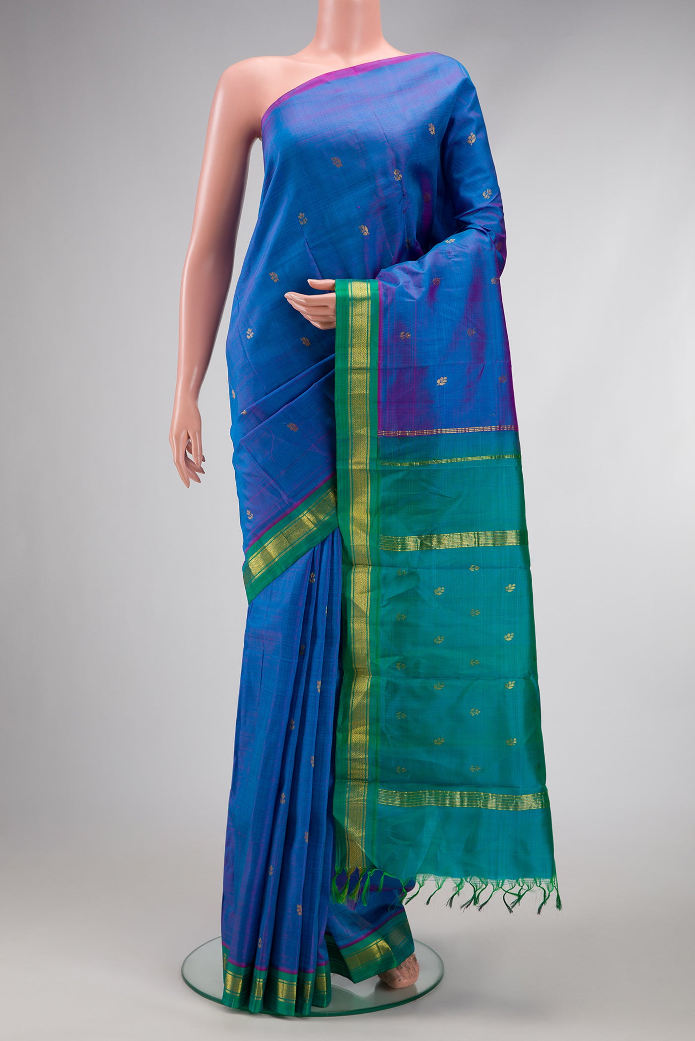 Peacock Blue Dual Tone Kanjivaram Silk Saree with Zari Butta on the body and Zari Border.  displayed on a mannequin