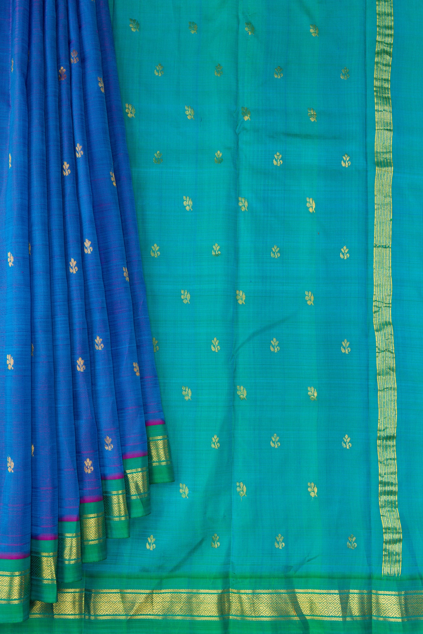 Pleats and pallu of Peacock Blue Dual Tone Kanjivaram Silk Saree with Zari Butta on the body and Zari Border. 