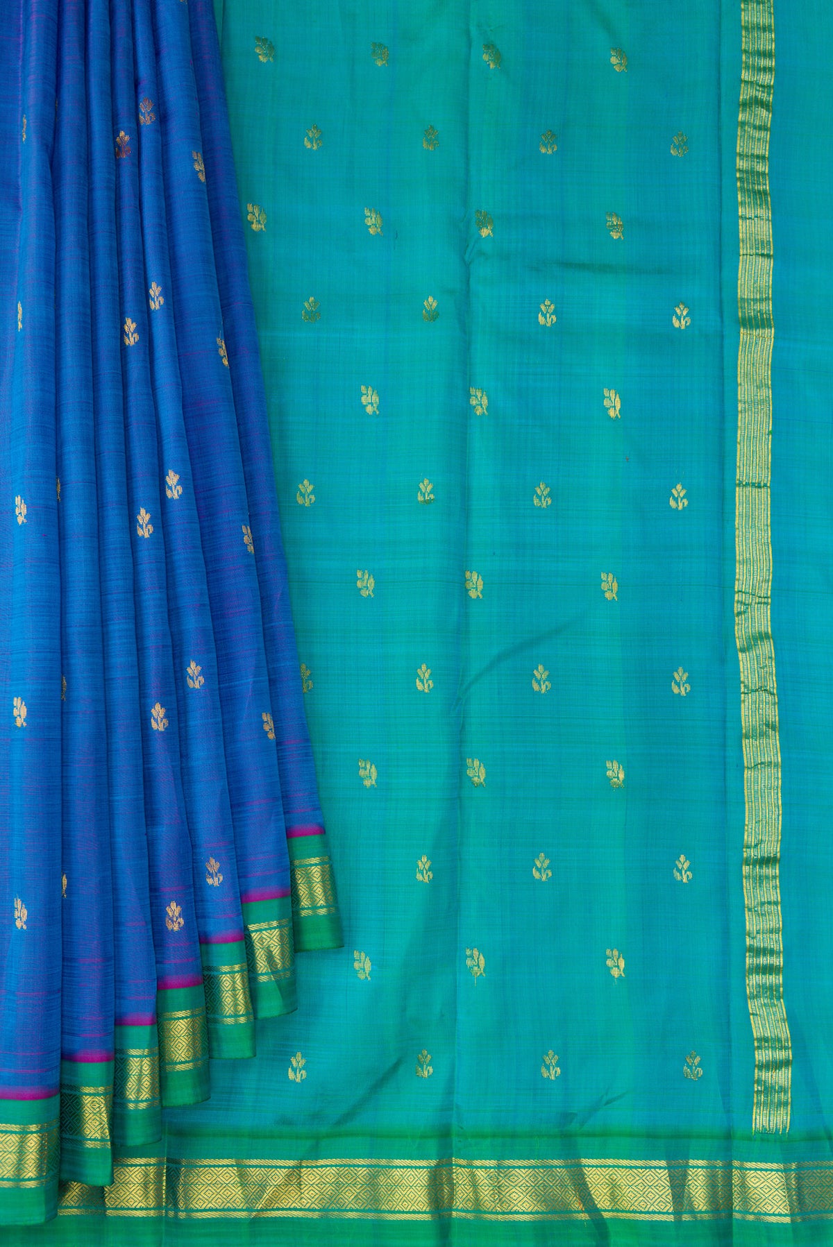 Pleats and pallu of Peacock Blue Dual Tone Kanjivaram Silk Saree with Zari Butta on the body and Zari Border. 