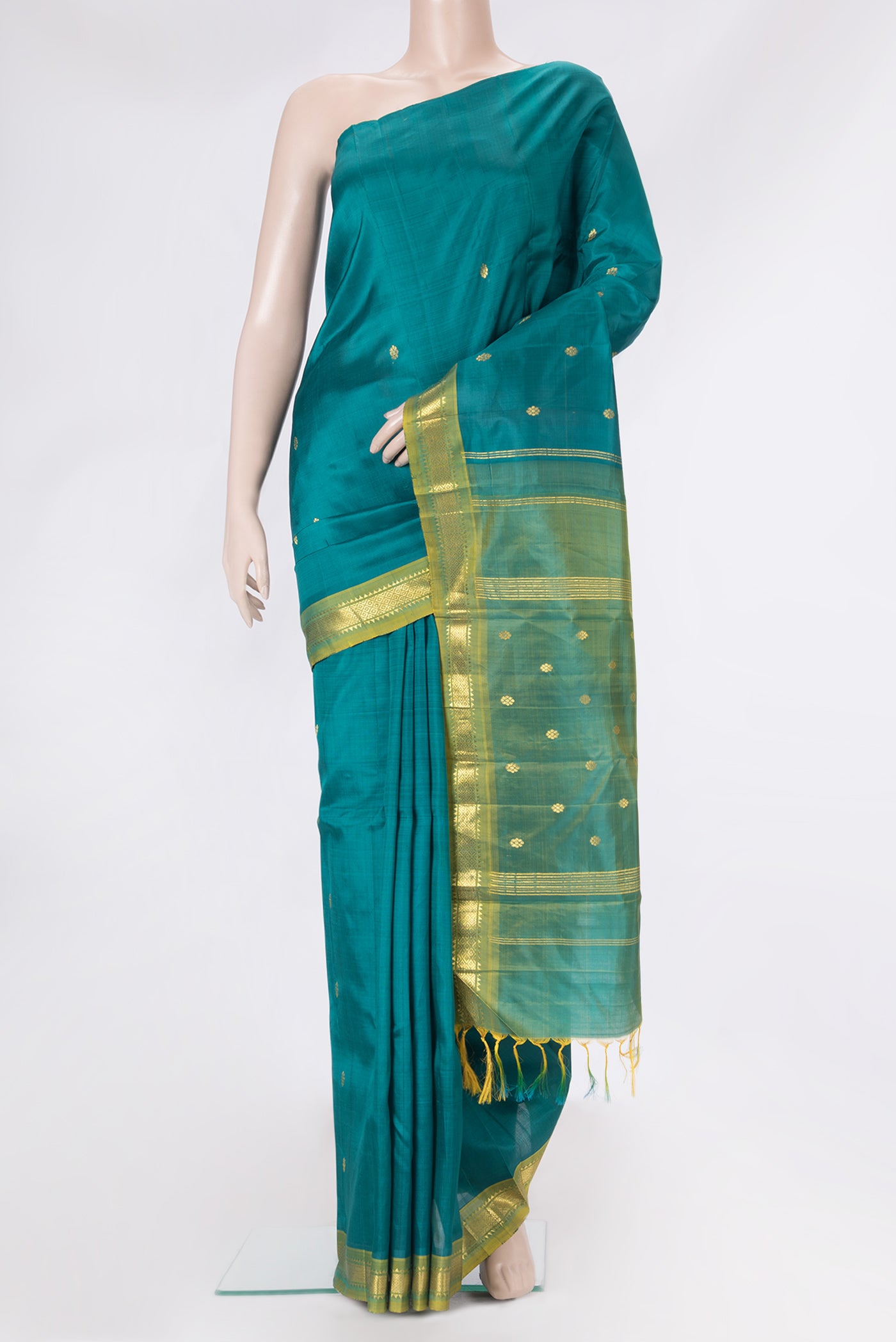 Peacock Blue Dual Tone Kanjivaram Silk Saree with Zari Butta on the body and One Side Border.  displayed on a mannequin