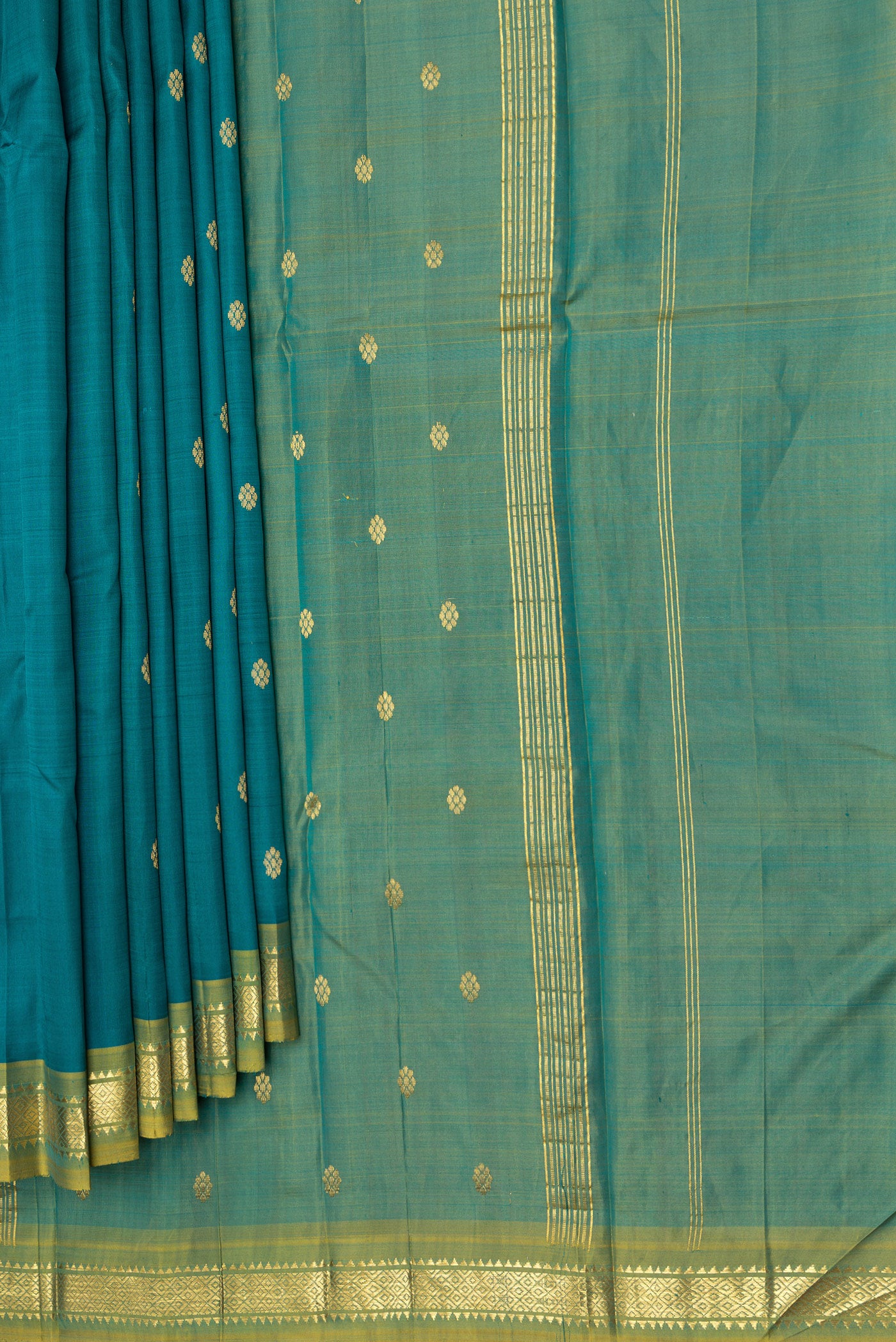 Pleats and pallu of Peacock Blue Dual Tone Kanjivaram Silk Saree with Zari Butta on the body and One Side Border. 