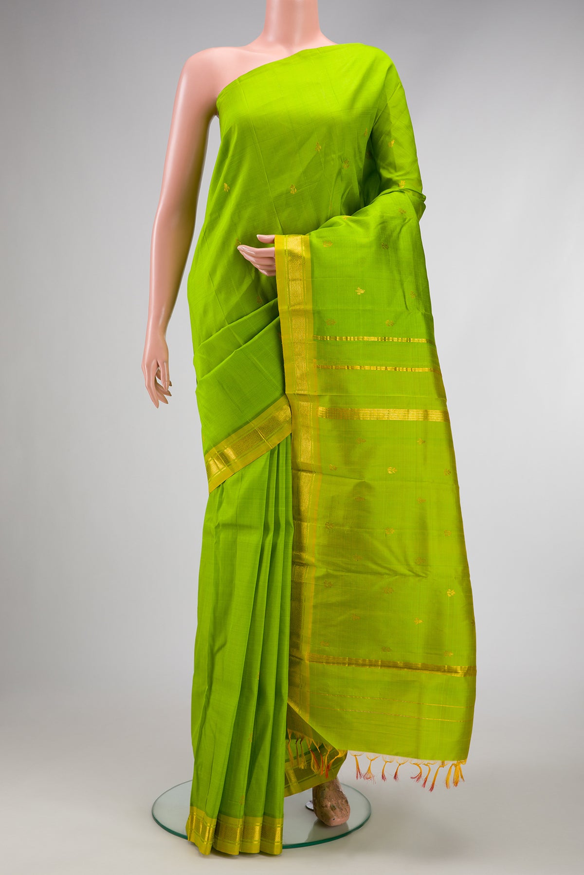Parrot Green Dual Tone Kanjivaram Silk Saree with Zari Butta on the body and Zari Border.  displayed on a mannequin