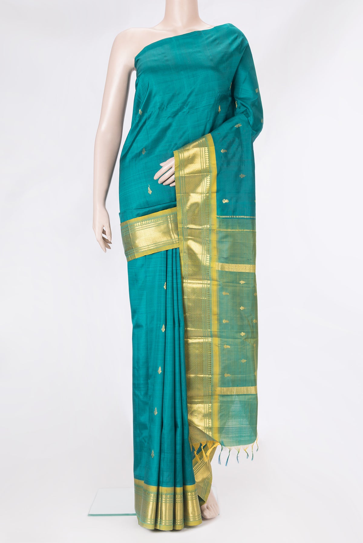 Peacock Blue Kanjivaram Silk Saree with Zari Butta on the body and One Side Border.  displayed on a mannequin