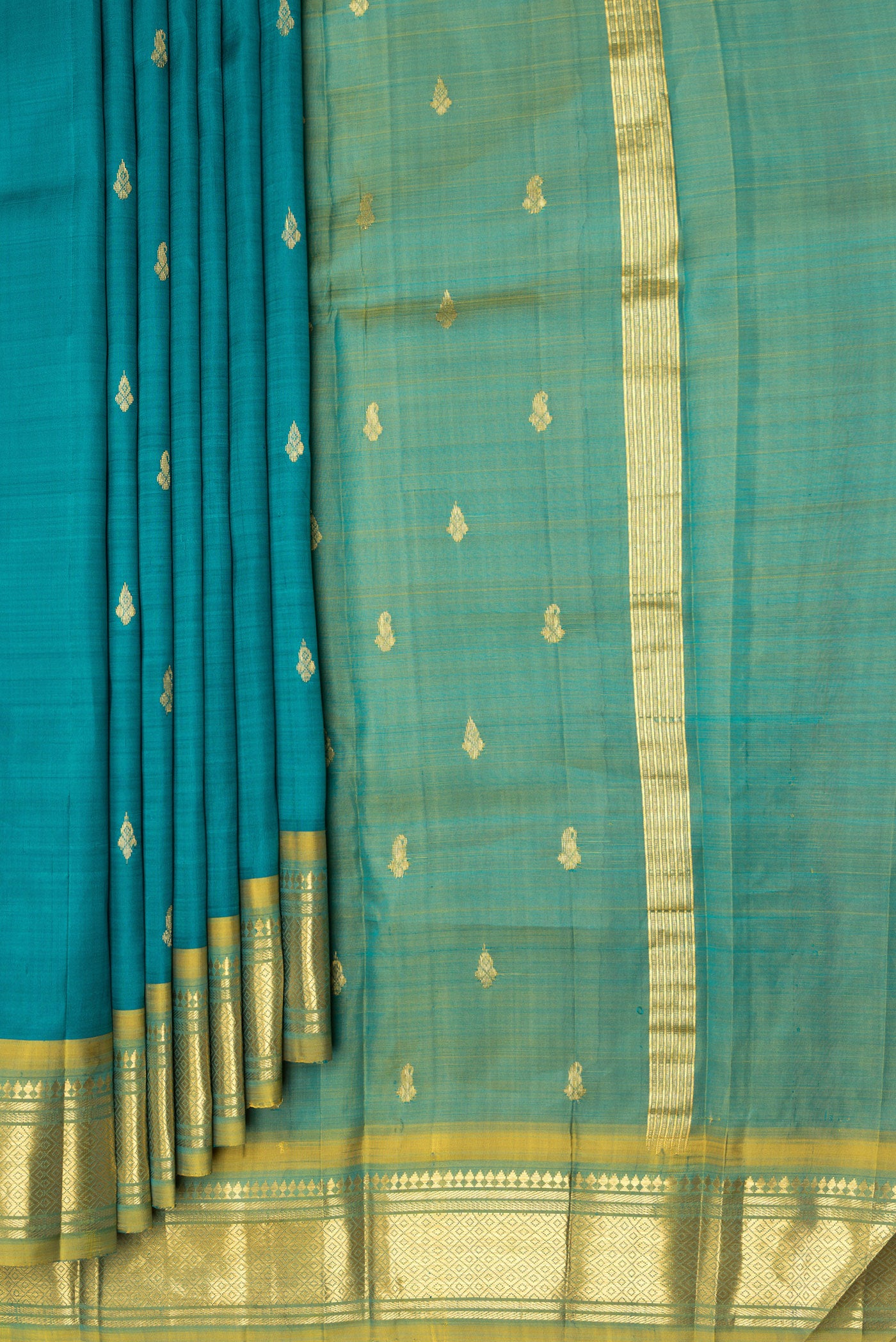Pleats and pallu of Peacock Blue Kanjivaram Silk Saree with Zari Butta on the body and One Side Border. 