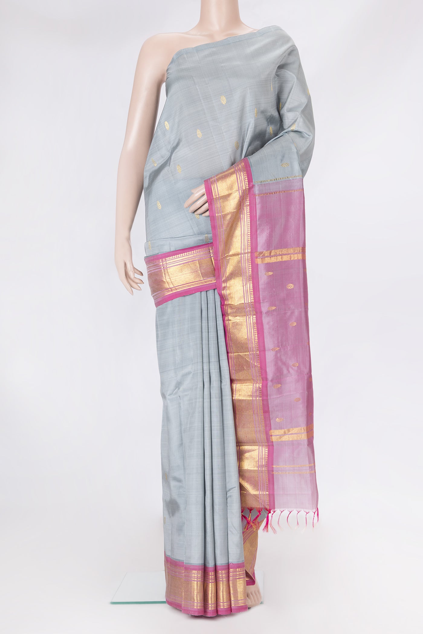 Grey Kanjivaram Silk Saree with Zari Butta on the body and One Side Border.  displayed on a mannequin