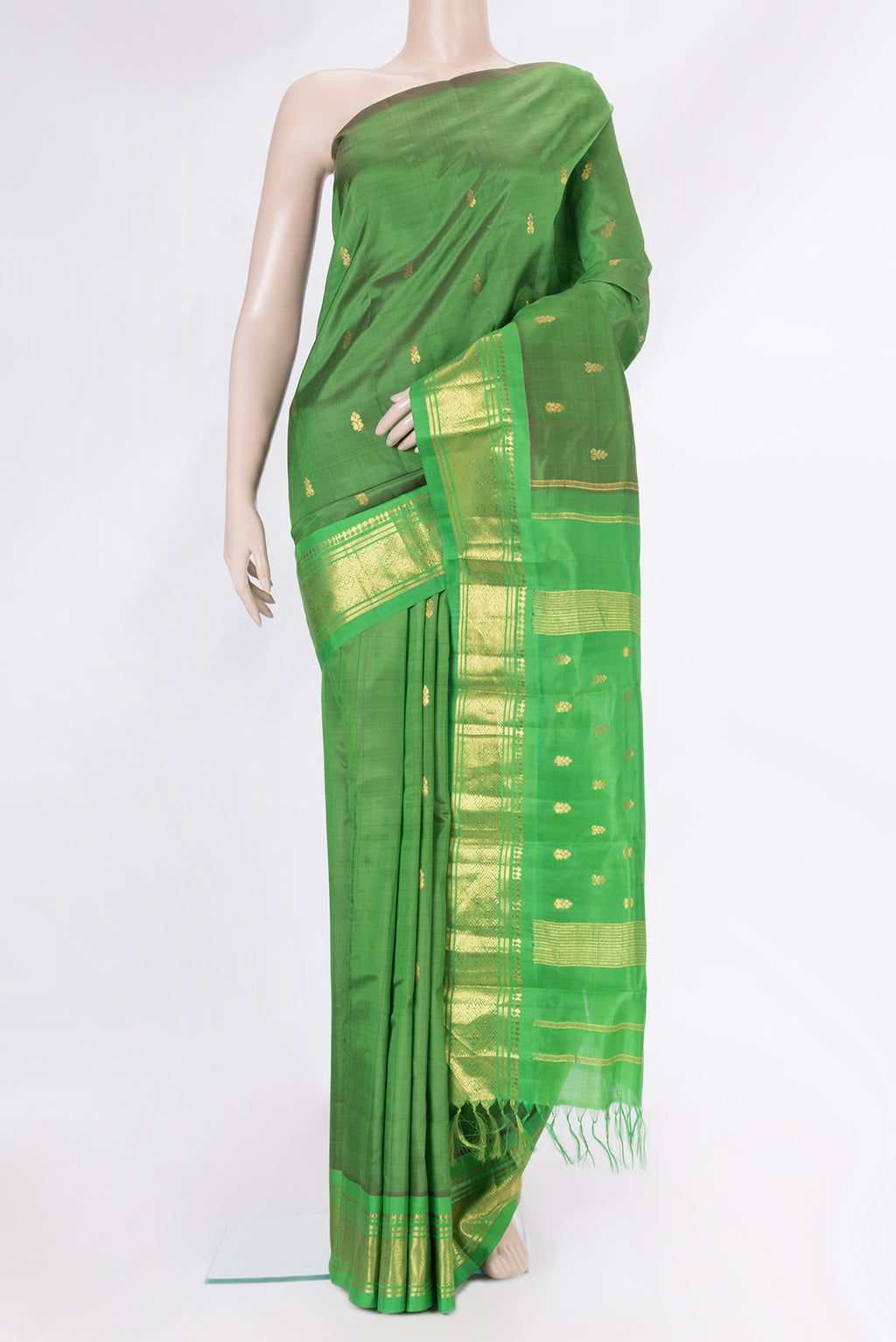 Green Kanjivaram Silk Saree with Zari Butta on the body and One Side Border.  displayed on a mannequin