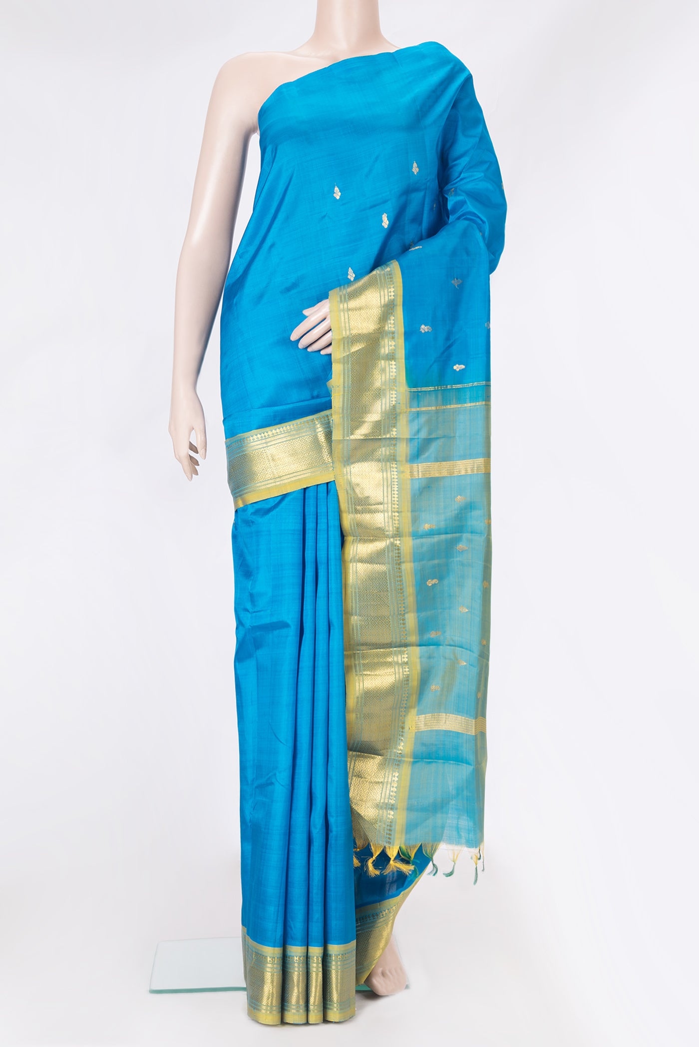 Sky Blue Kanjivaram Silk Saree with Zari Butta on the body and One Side Border.  displayed on a mannequin