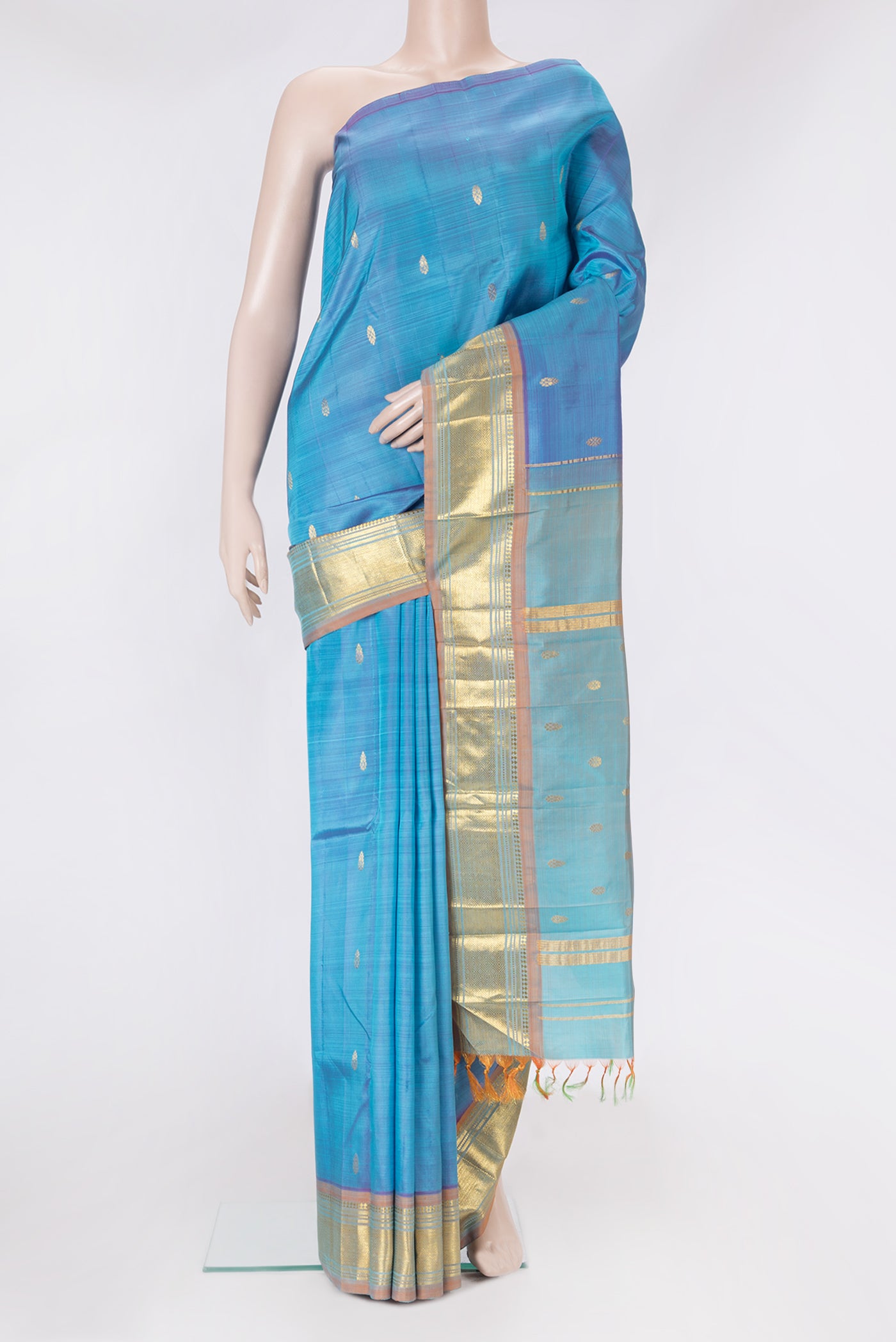 Blue Kanjivaram Silk Saree with Zari Butta on the body and One Side Border.  displayed on a mannequin
