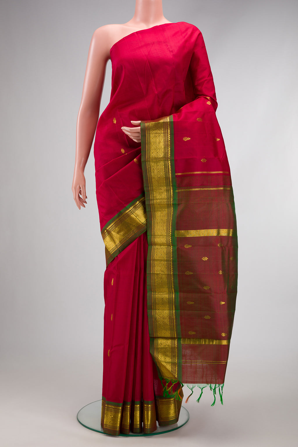 Maroon Kanjivaram Silk Saree with Zari Butta on the body and One Side Border.  displayed on a mannequin