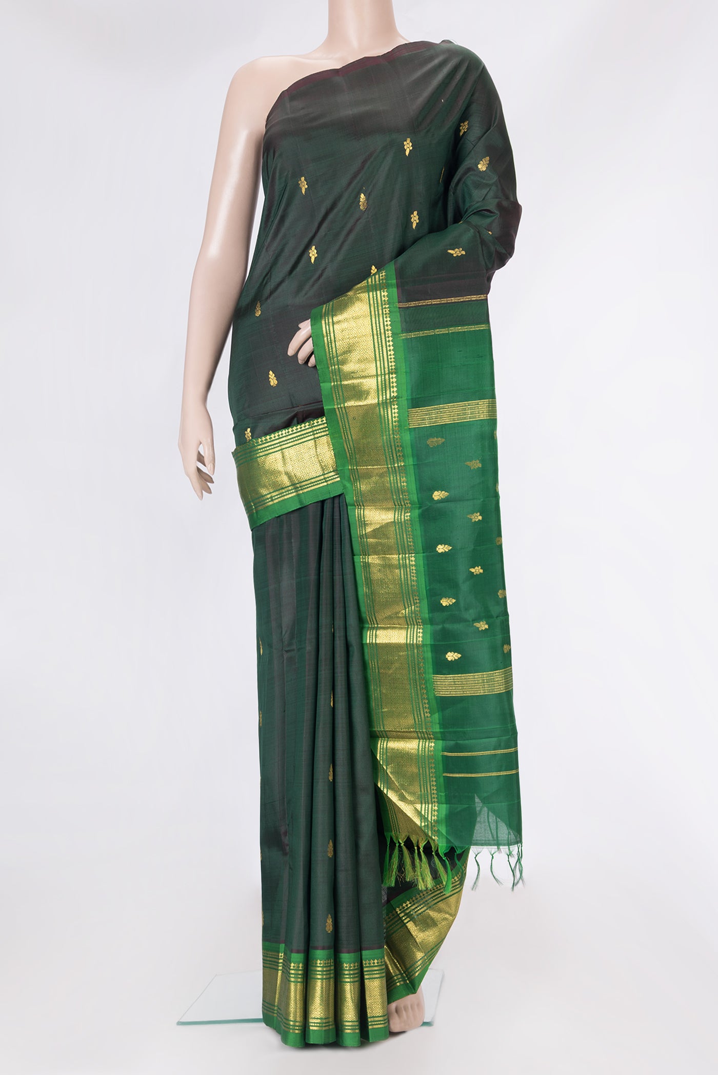 Bottle Green Kanjivaram Silk Saree with Zari Butta on the body and One Side Border.  displayed on a mannequin