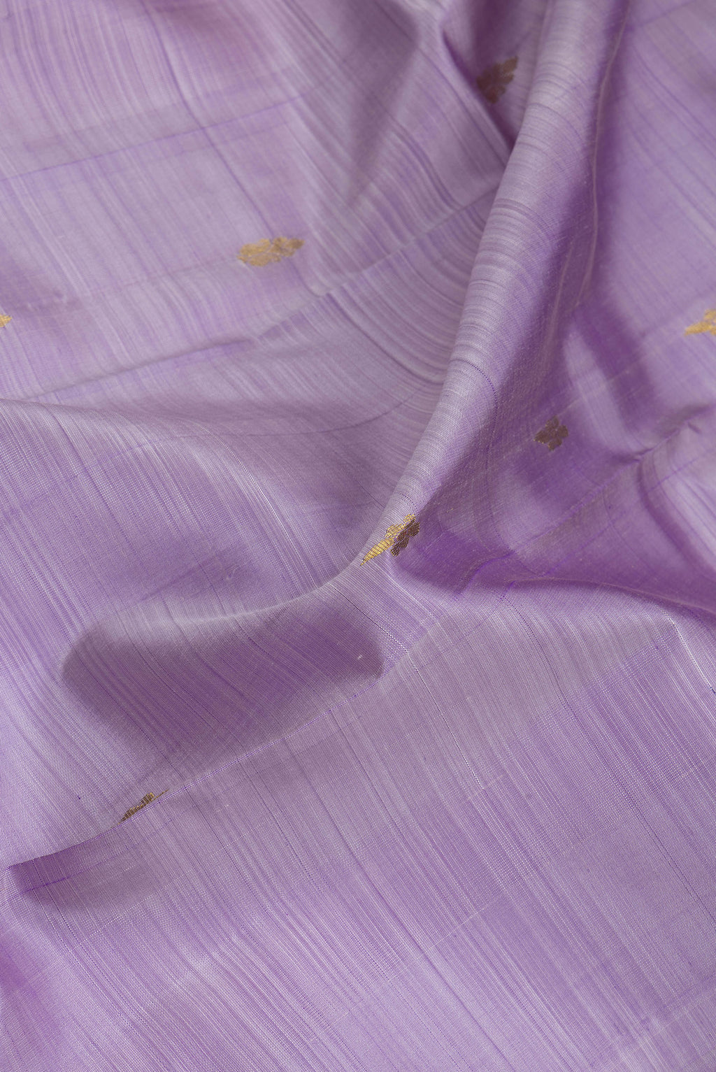 Close up of Lavender Kanjivaram Silk Saree with Zari Butta on the body and One Side Border.  displaying folds