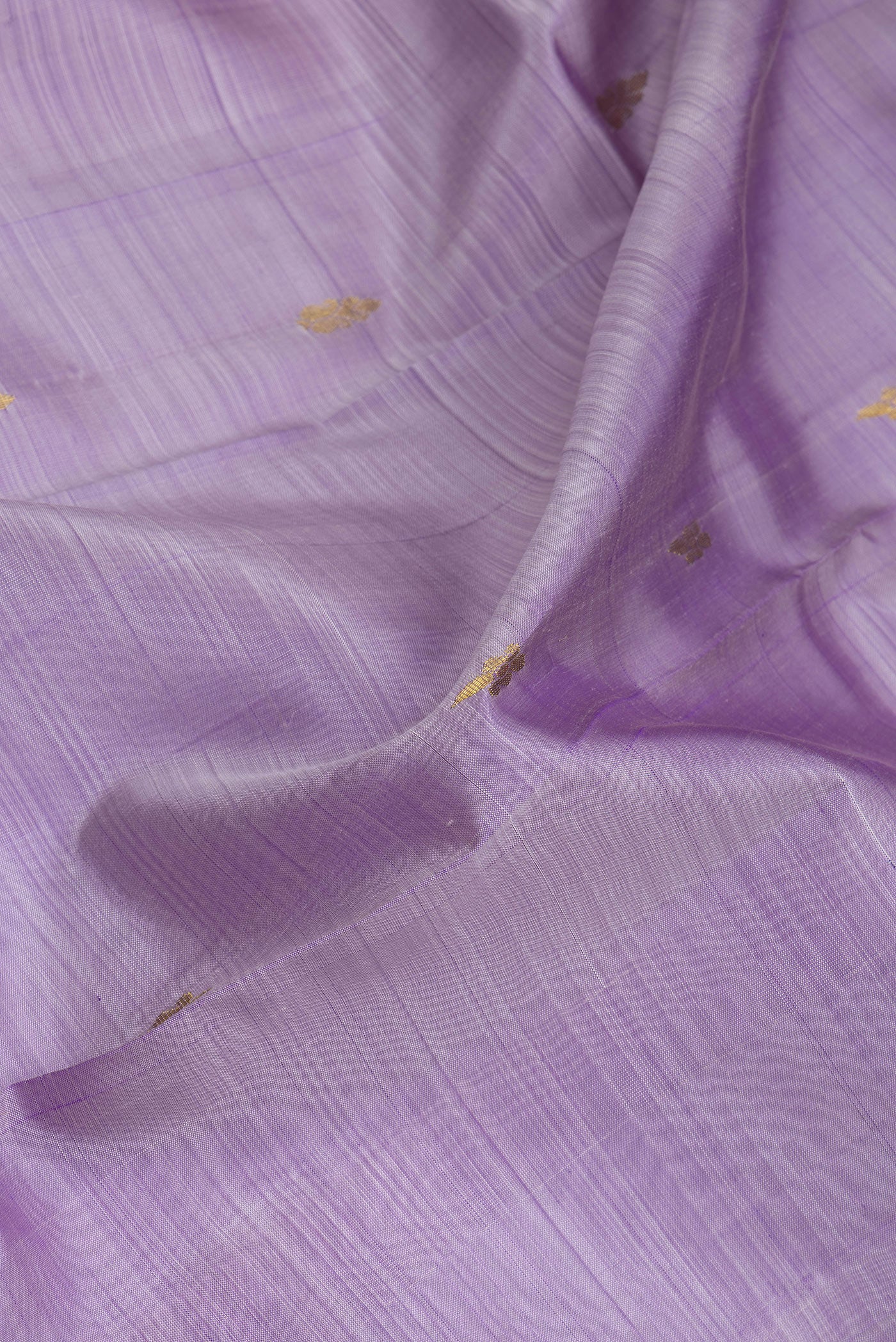 Close up of Lavender Kanjivaram Silk Saree with Zari Butta on the body and One Side Border.  displaying folds