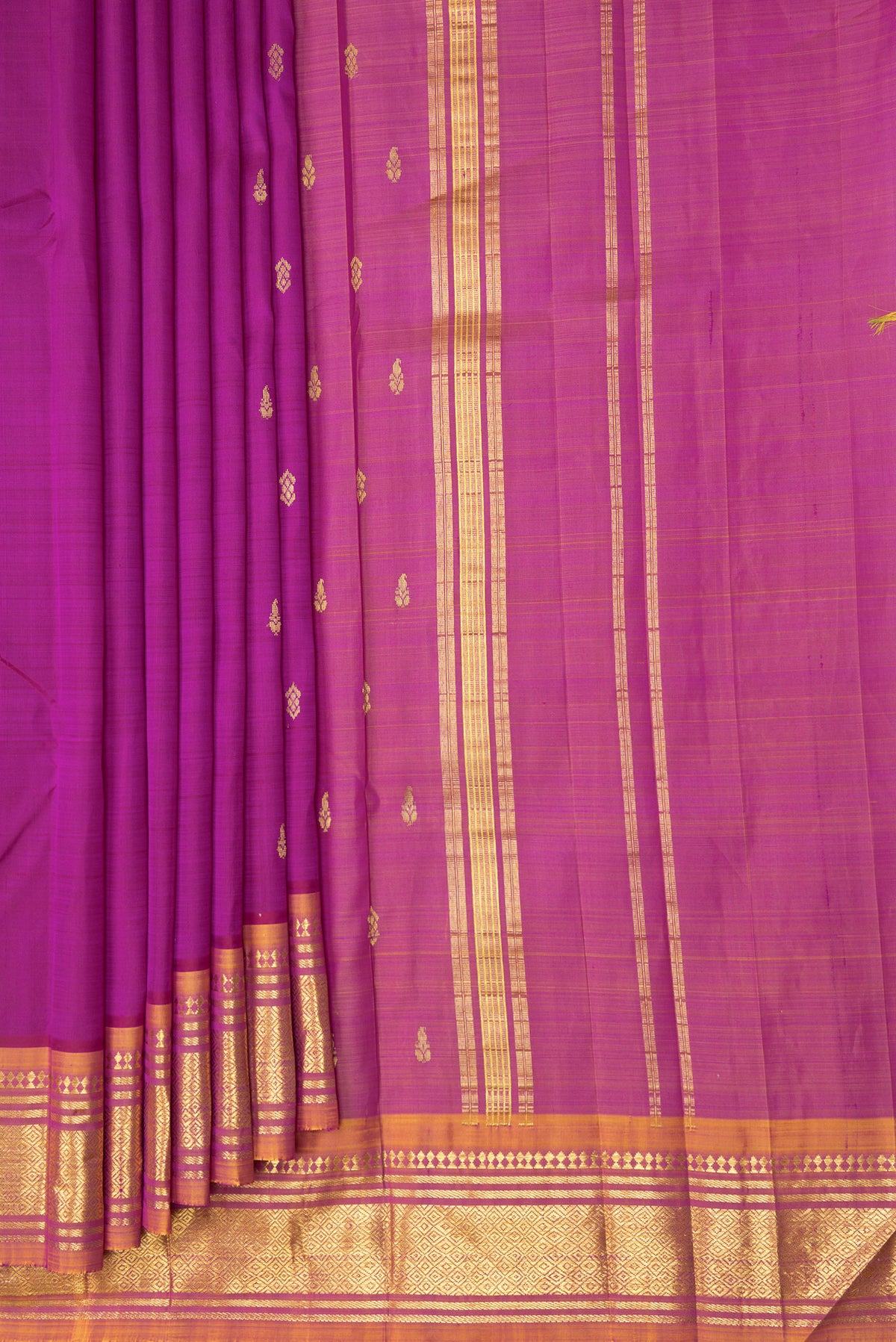 Pleats and pallu of Magenta Kanjivaram Silk Saree with Zari Butta on the body and One Side Border. 