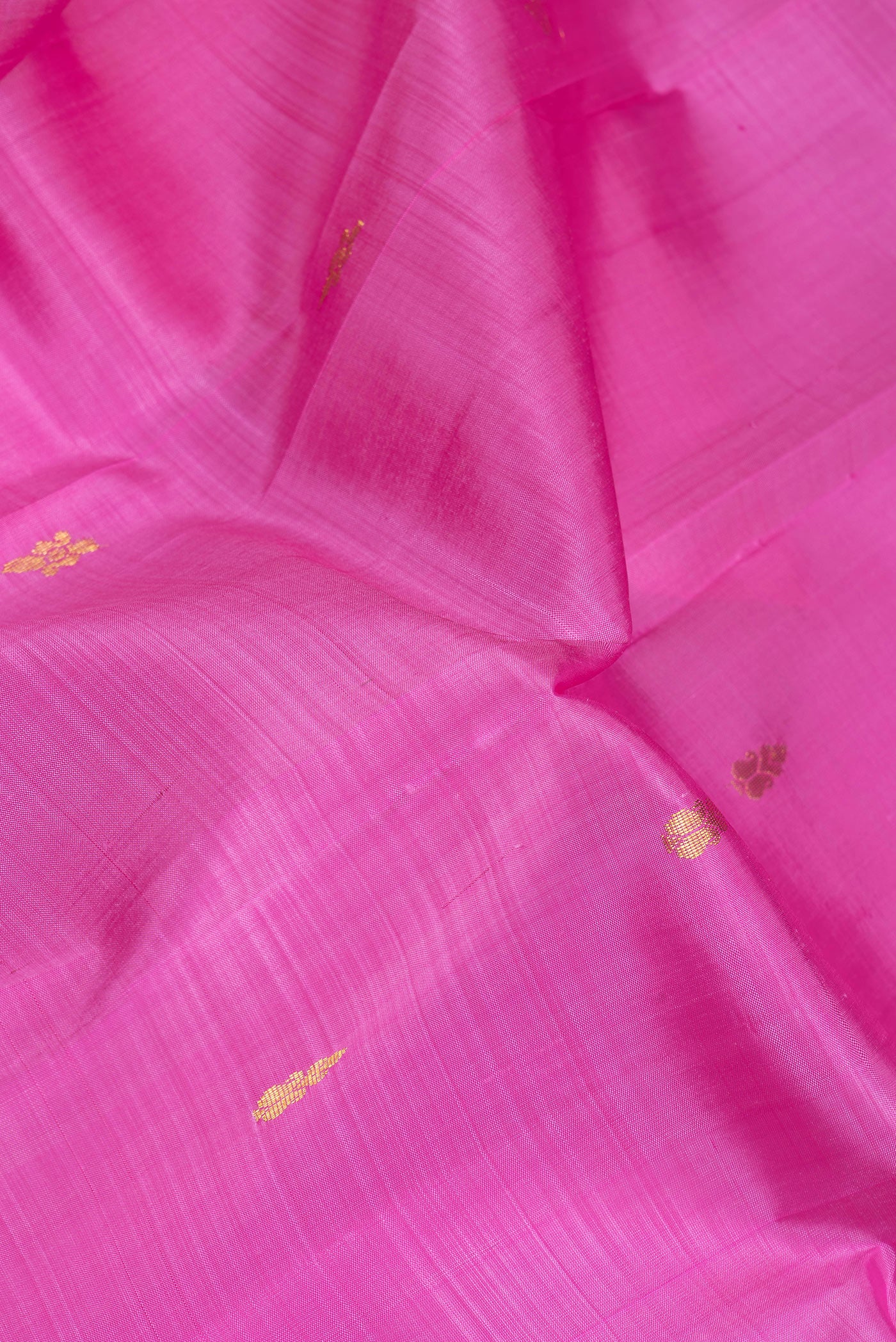 Close up of Pink Dual Tone Kanjivaram Silk Saree with Zari Butta on the body and One Side Border.  displaying folds