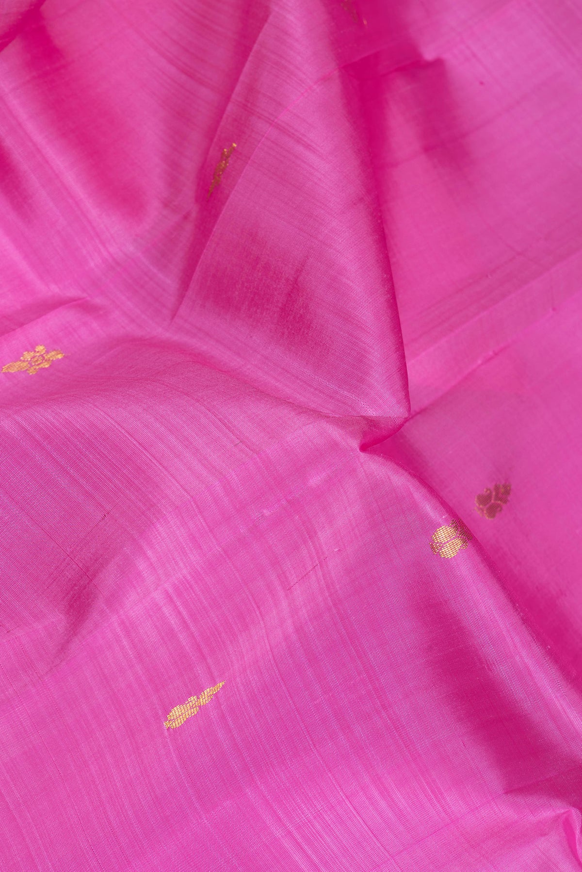 Close up of Pink Dual Tone Kanjivaram Silk Saree with Zari Butta on the body and One Side Border.  displaying folds