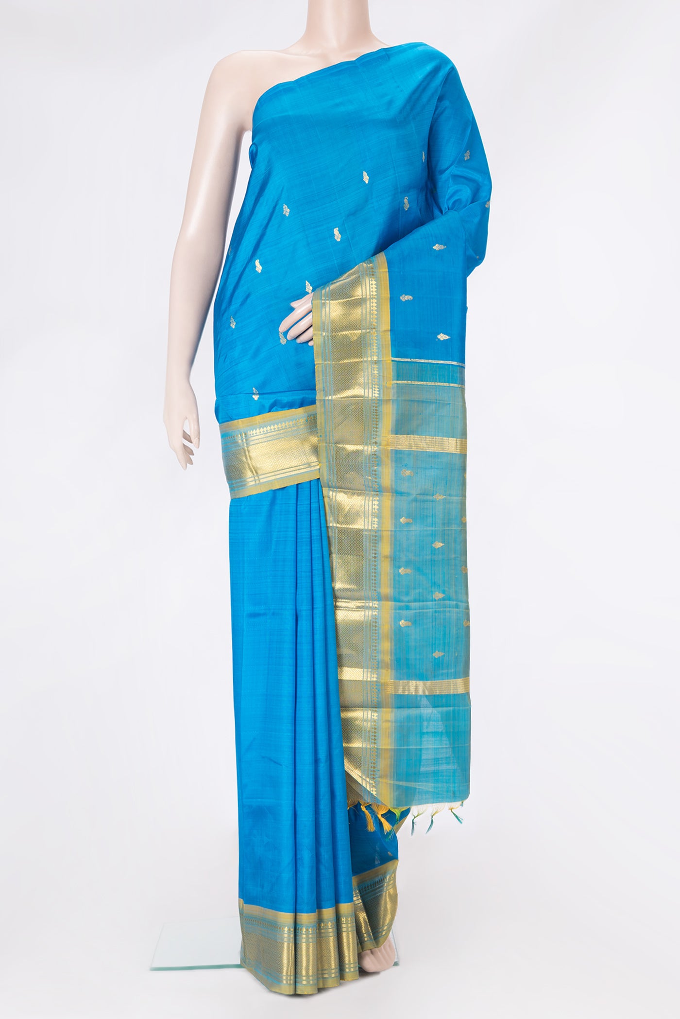 Sky Blue Kanjivaram Silk Saree with Zari Butta on the body and One Side Border.  displayed on a mannequin