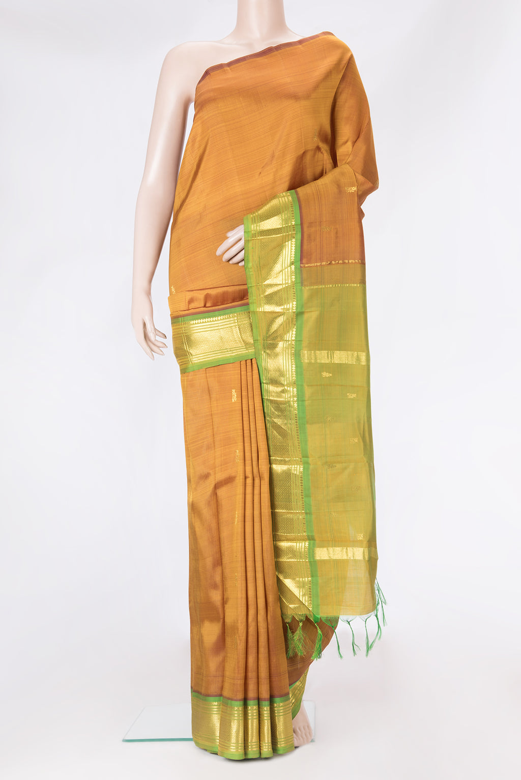 Gold Dual Tone Kanjivaram Silk Saree with Zari Butta on the body and One Side Border.  displayed on a mannequin