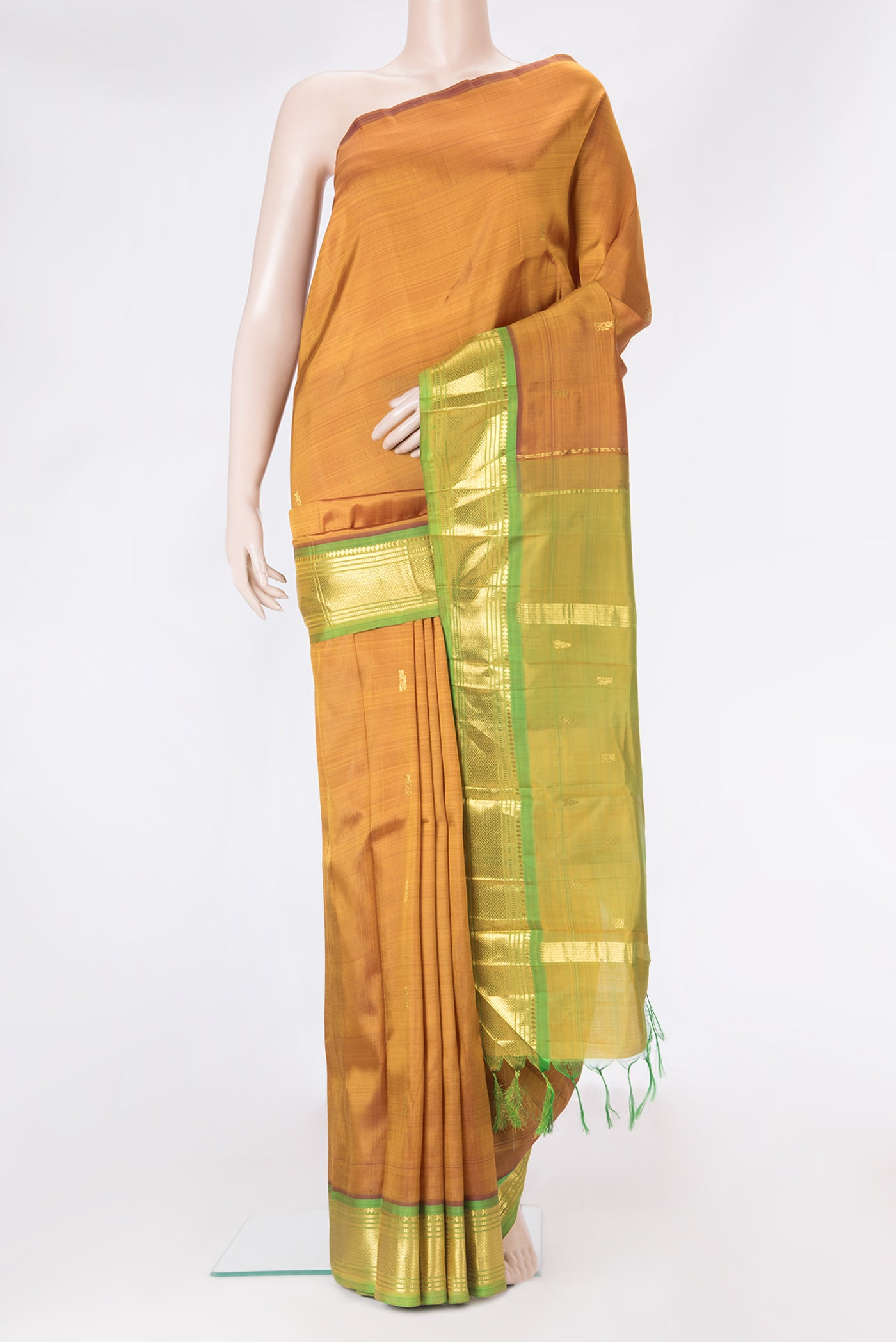 Gold Dual Tone Kanjivaram Silk Saree with Zari Butta on the body and One Side Border.  displayed on a mannequin