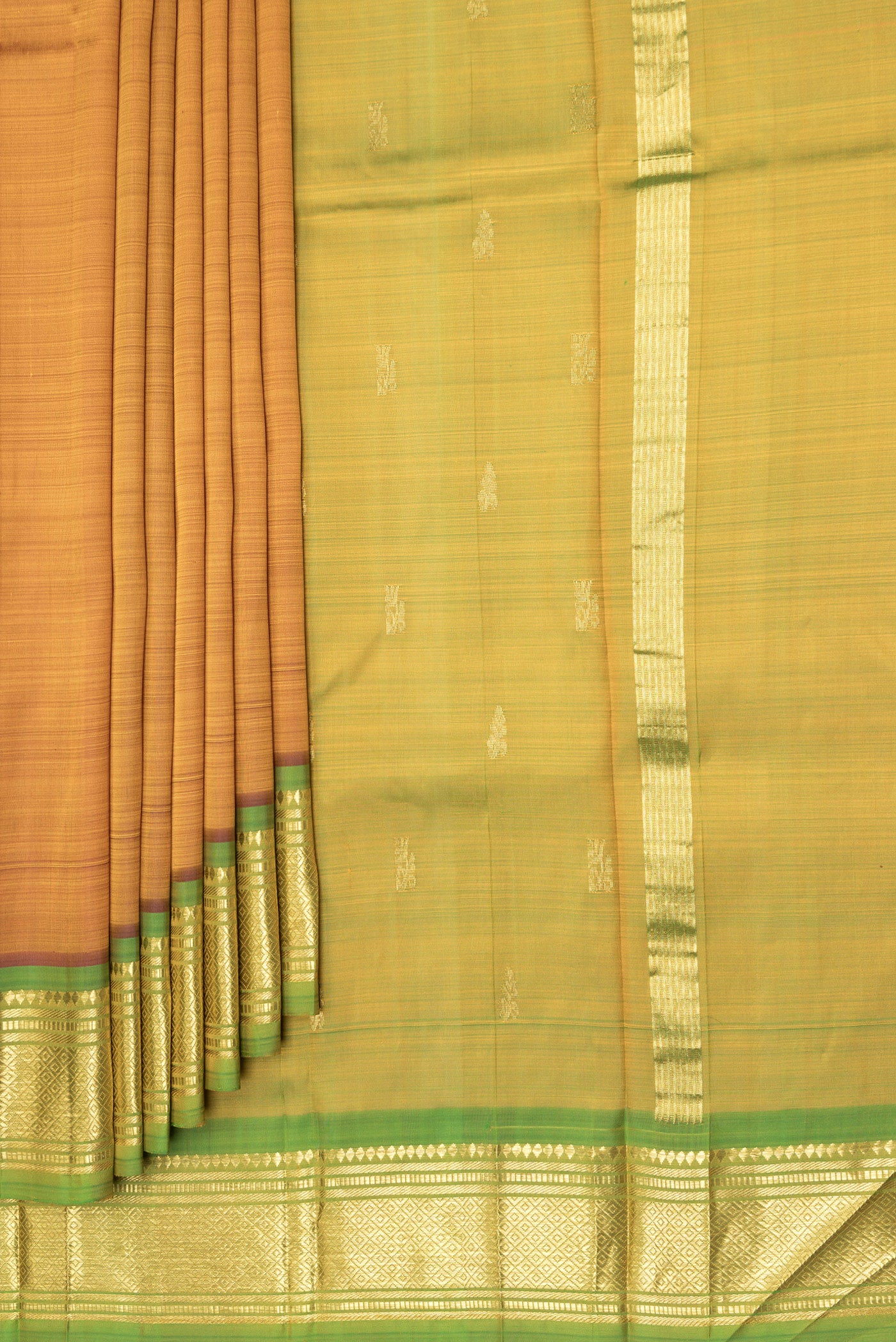 Pleats and pallu of Gold Dual Tone Kanjivaram Silk Saree with Zari Butta on the body and One Side Border. 
