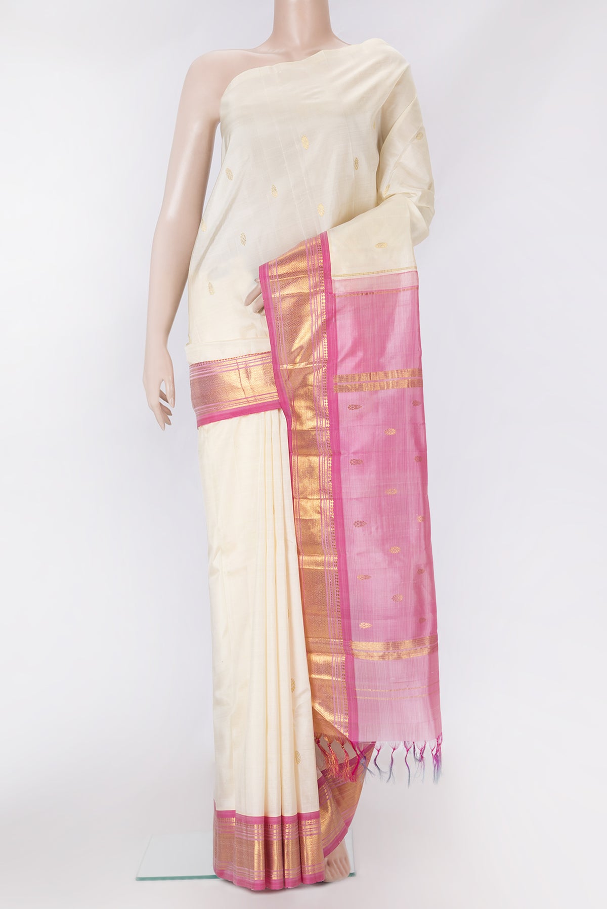 Off White Kanjivaram Silk Saree with Zari Butta on the body and One Side Border.  displayed on a mannequin