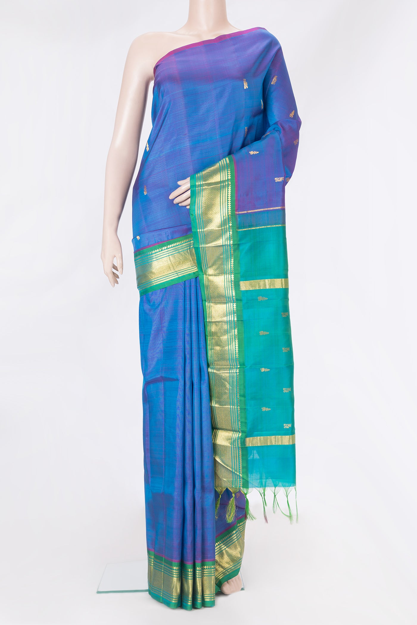Peacock Blue Dual Tone Kanjivaram Silk Saree with Zari Butta on the body and One Side Border.  displayed on a mannequin