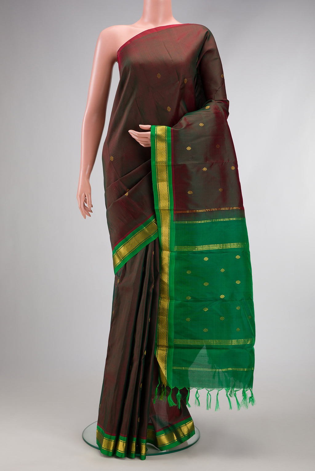 Maroon Dual Tone Kanchipuram Silk Saree with Zari Butta on the body and Zari Border.  displayed on a mannequin