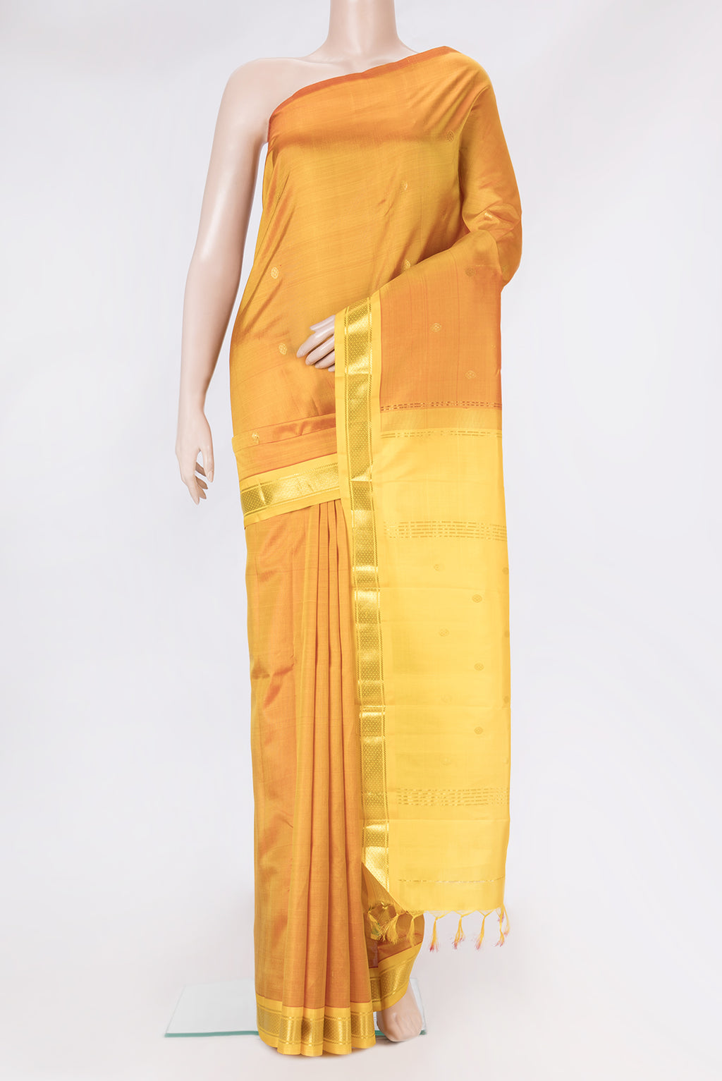 Mustard Dual Tone Kanchipuram Silk Saree with Zari Butta on the body and One Side Border.  displayed on a mannequin