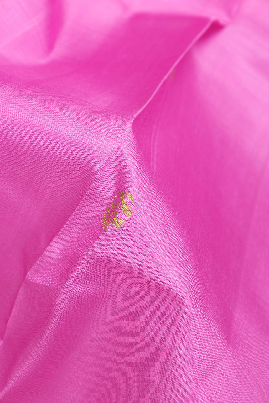 Close up of Pink Kanchipuram Silk Saree with Zari Butta on the body and One Side Border.  displaying folds
