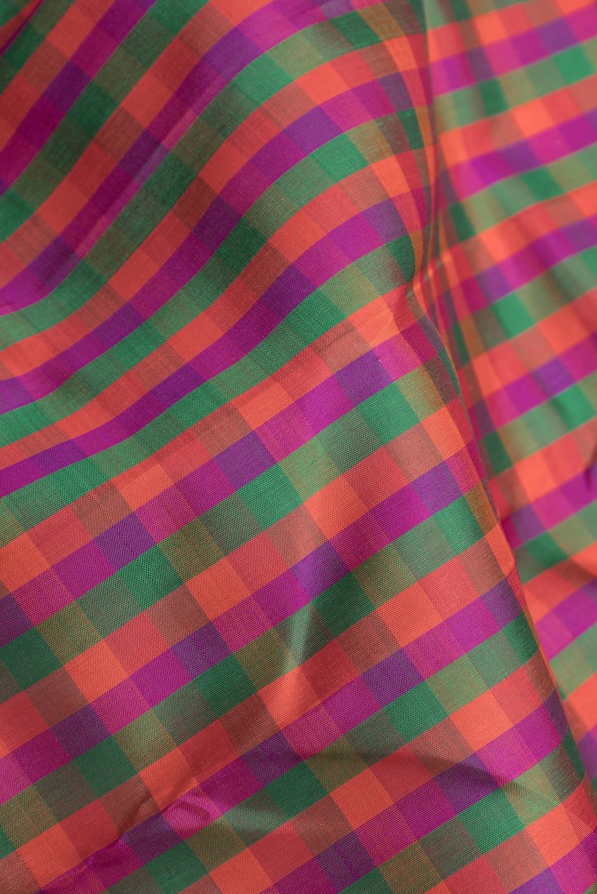 Close up of Multi Color Kanchipuram Silk Saree with Checked design on the body and One Side Border.  displaying folds