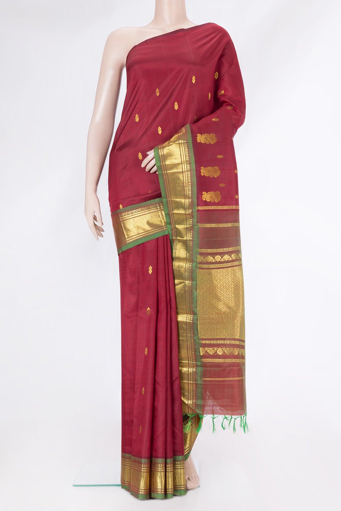 Maroon Kanjivaram Silk Saree with Zari Butta on the body and One Side Border.  displayed on a mannequin