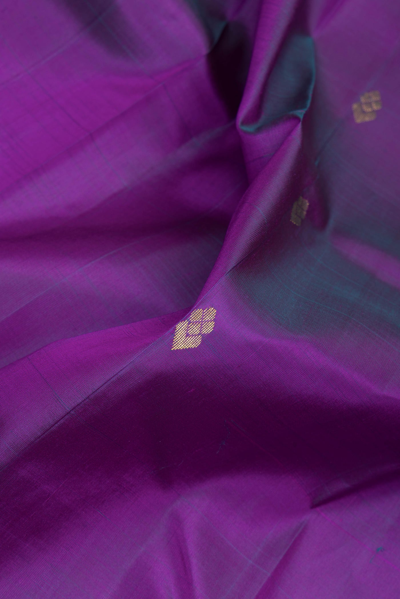 Close up of Purple Dual Tone Kanjivaram Silk Saree with Zari Butta on the body and One Side Border.  displaying folds