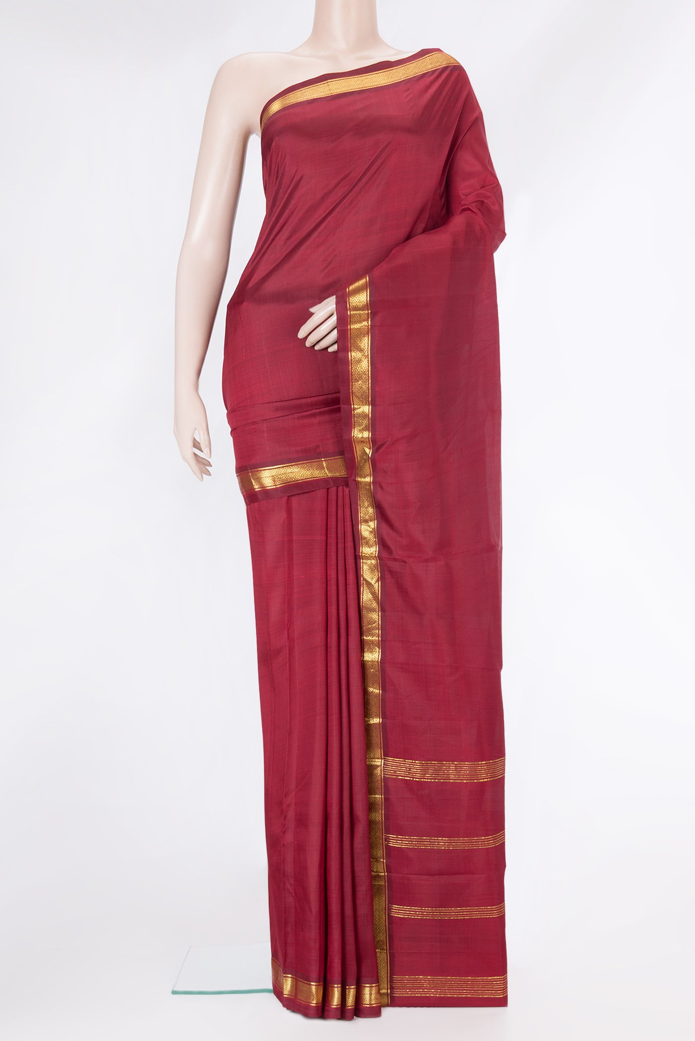 Maroon Kanjivaram Silk Saree with Plain Body and Zari Border.  displayed on a mannequin