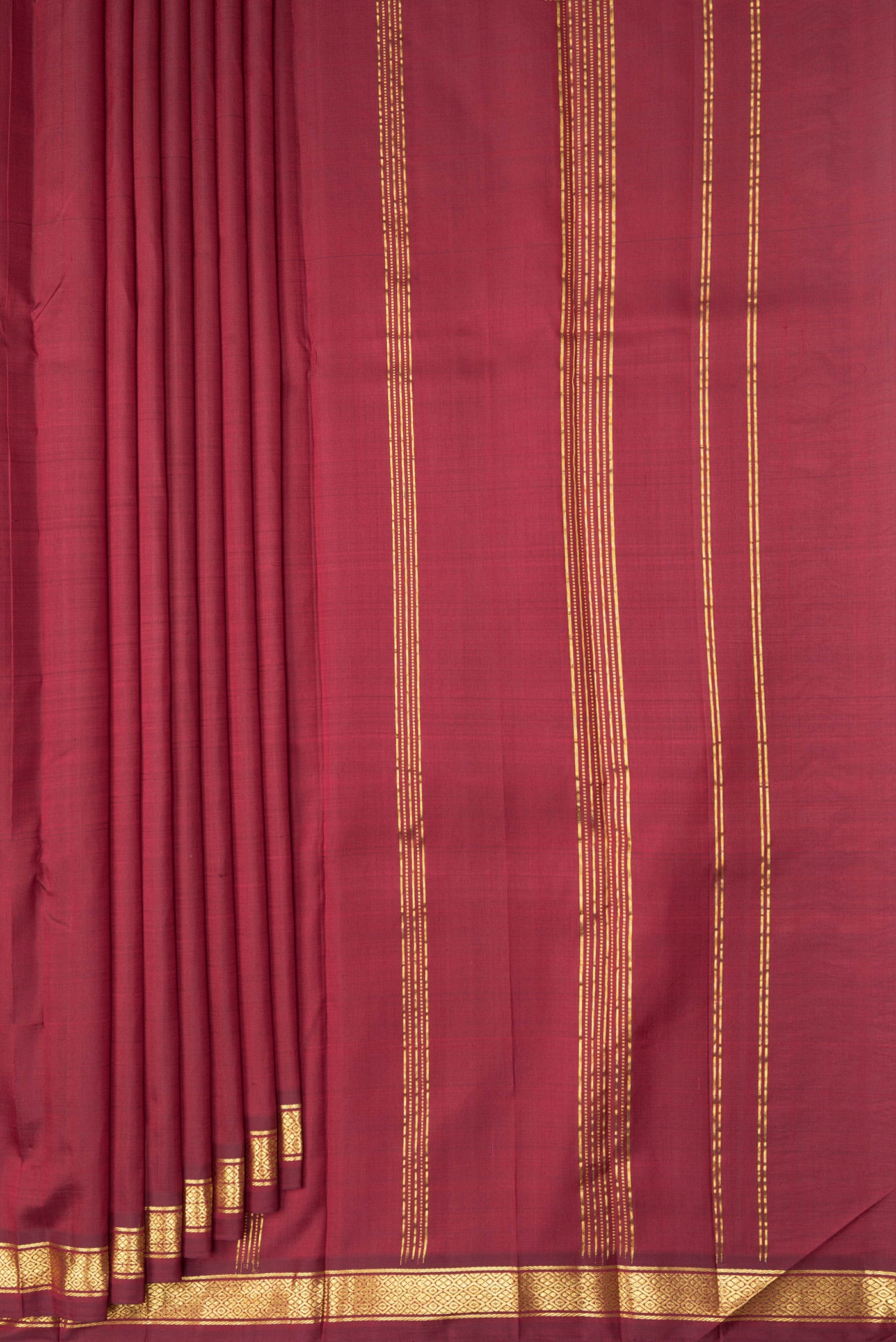 Pleats and pallu of Maroon Kanjivaram Silk Saree with Plain Body and Zari Border. 