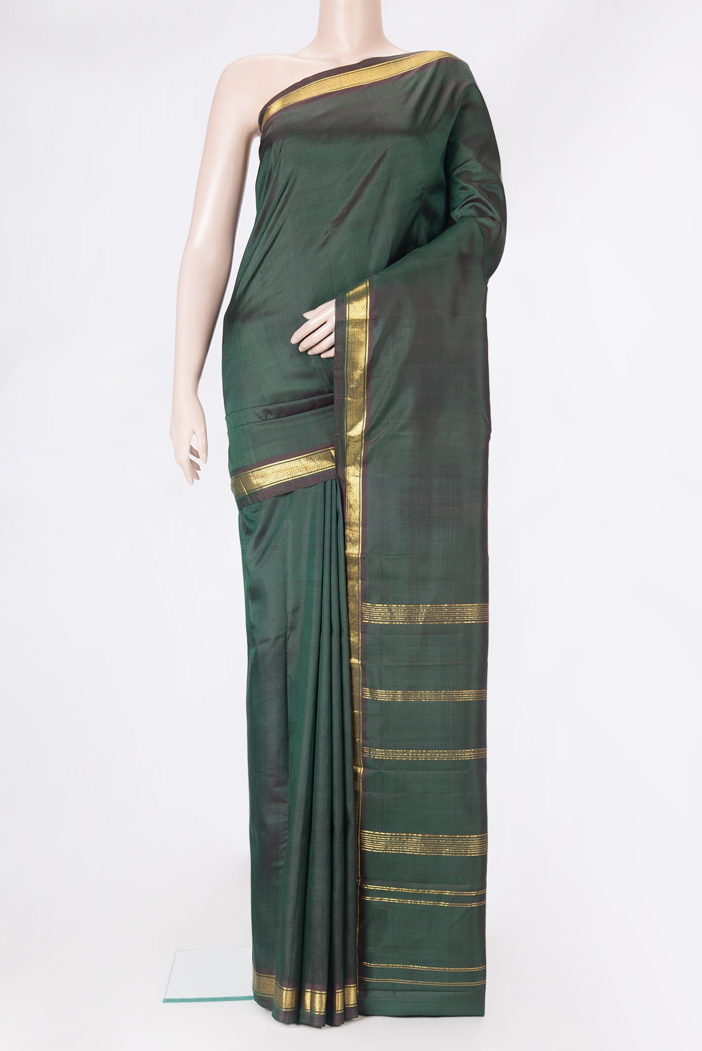 Bottle Green Dual Tone Kanjivaram Silk Saree with Plain Body and Zari Border.  displayed on a mannequin
