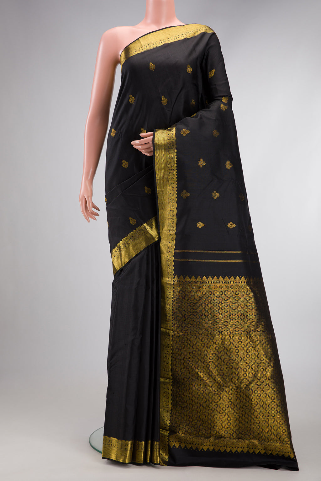 Black Kanjivaram Silk Saree with Zari Butta on the body and Zari Border.  displayed on a mannequin