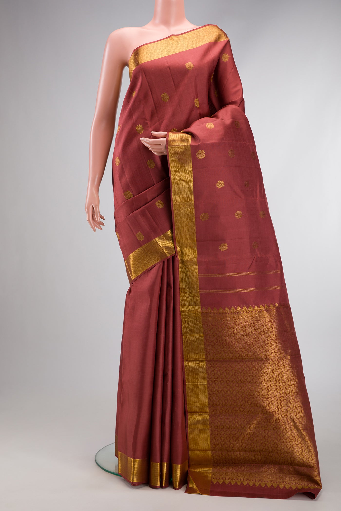Maroon Dual Tone Kanjivaram Silk Saree with Zari Butta on the body and Zari Border.  displayed on a mannequin