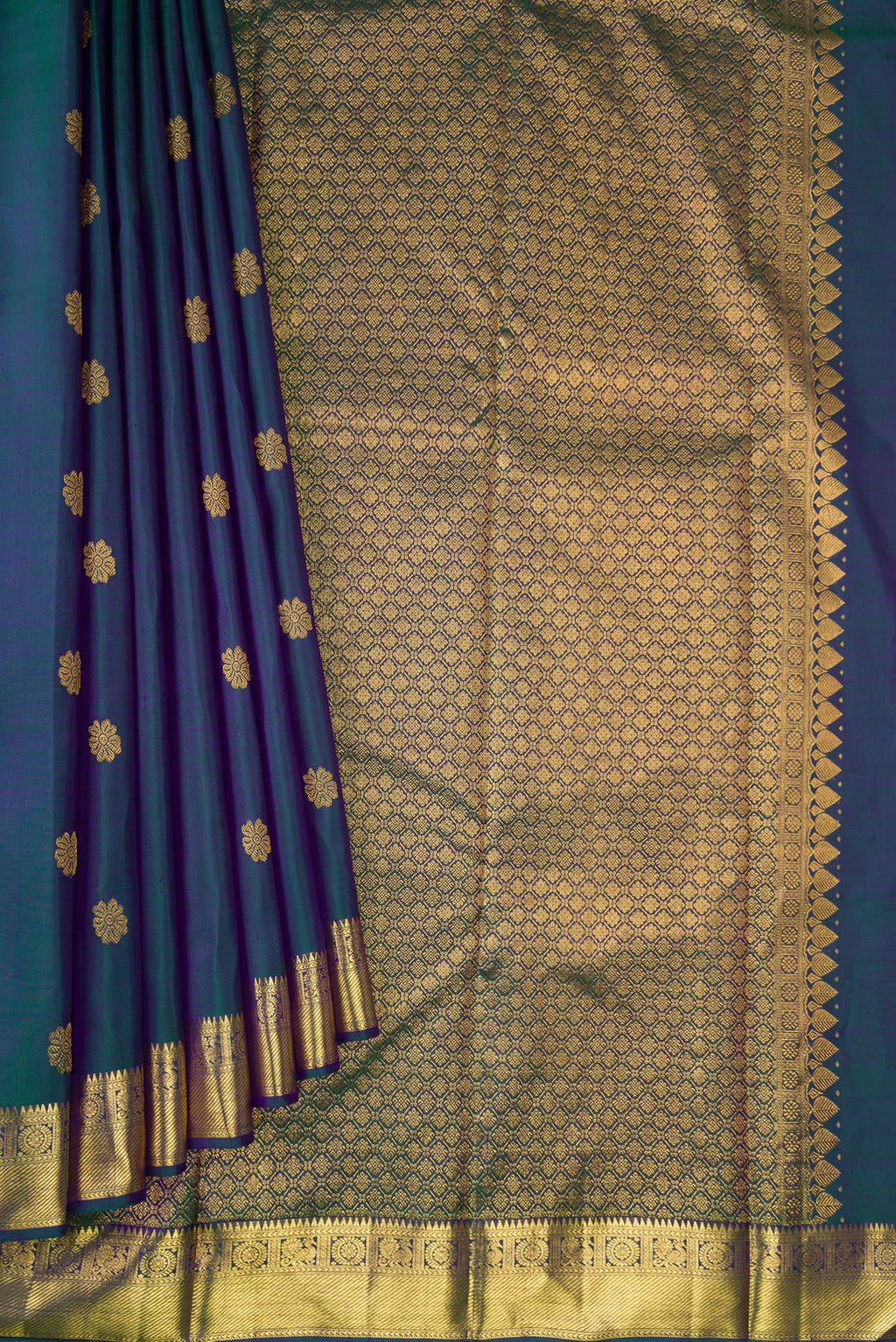 Pleats and pallu of Peacock Blue Dual Tone Kanjivaram Silk Saree with Zari Butta on the body and Zari Border. 