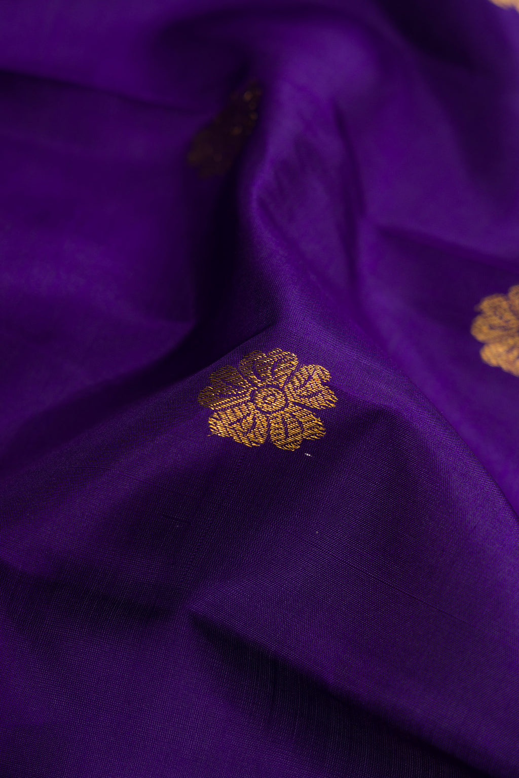 Close up of Violet Kanjivaram Silk Saree with Zari Butta on the body and Zari Border.  displaying folds