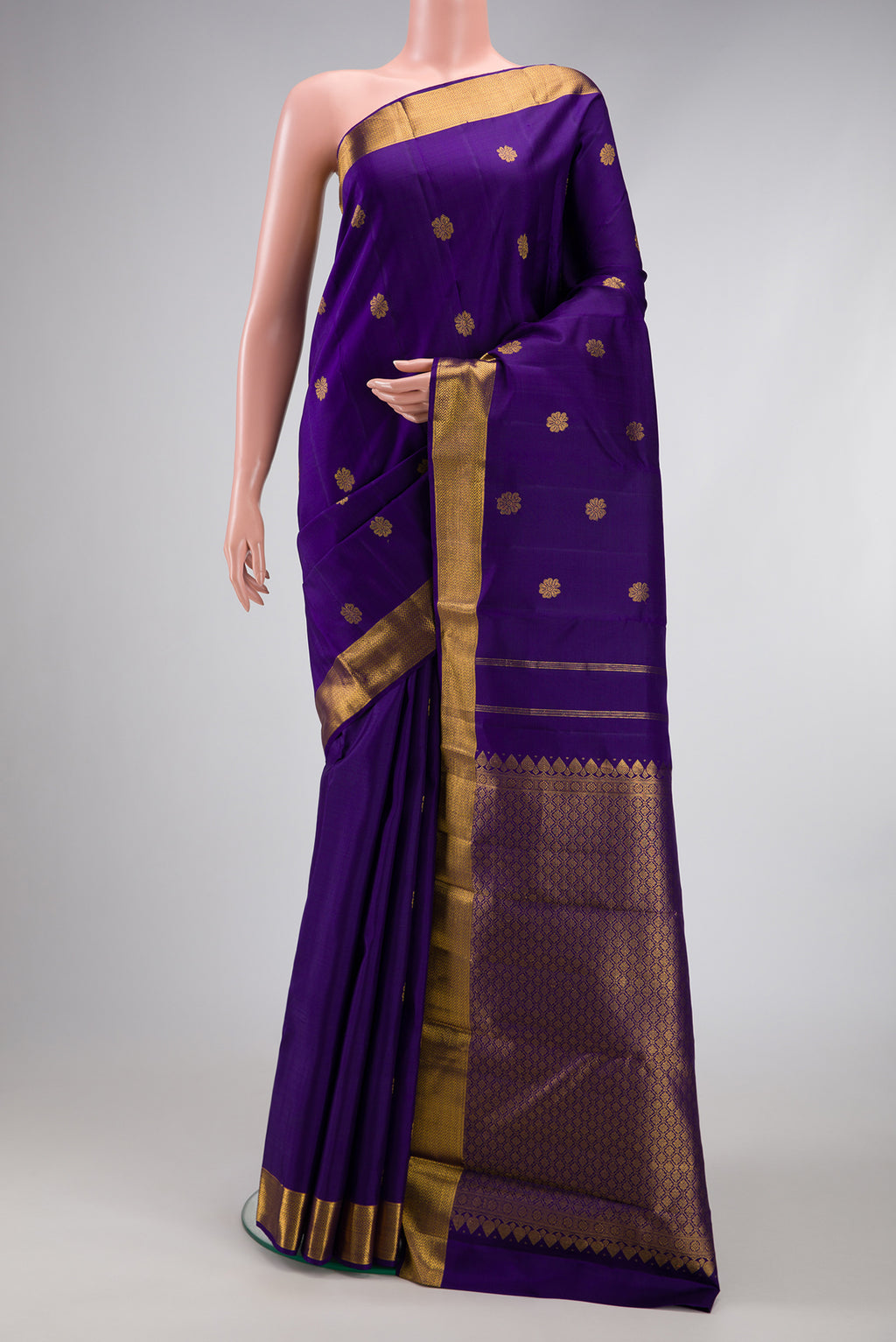 Violet Kanjivaram Silk Saree with Zari Butta on the body and Zari Border.  displayed on a mannequin