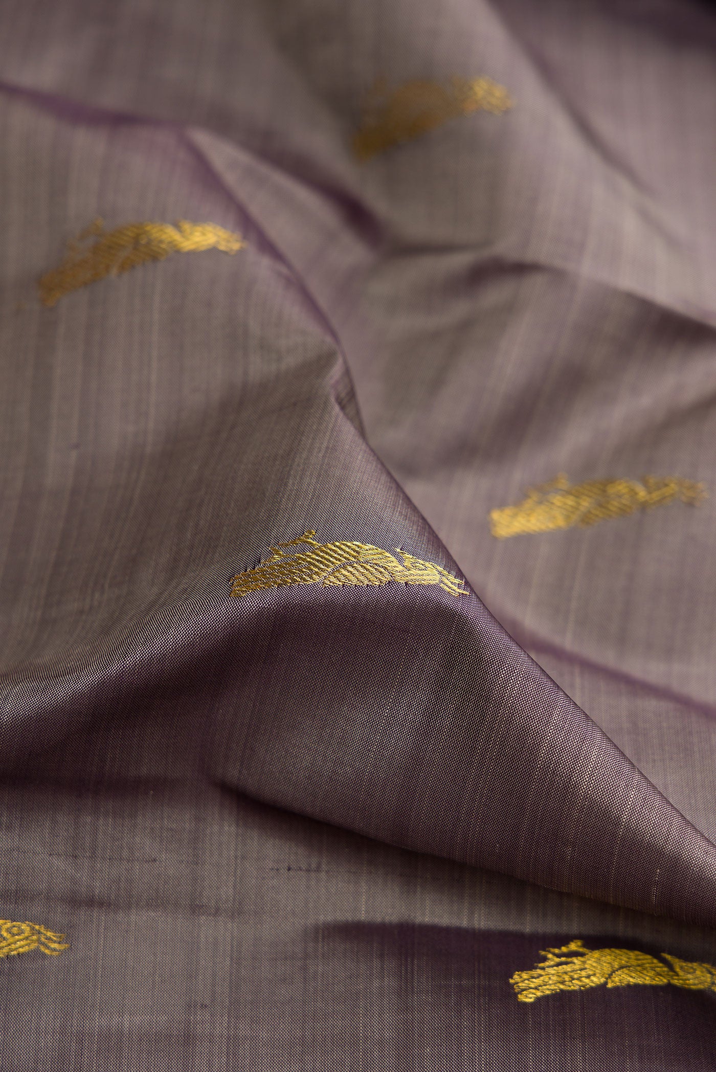 Close up of Grey Dual Tone Kanchipuram Silk Saree with Zari Butta on the body and Zari Border.  displaying folds