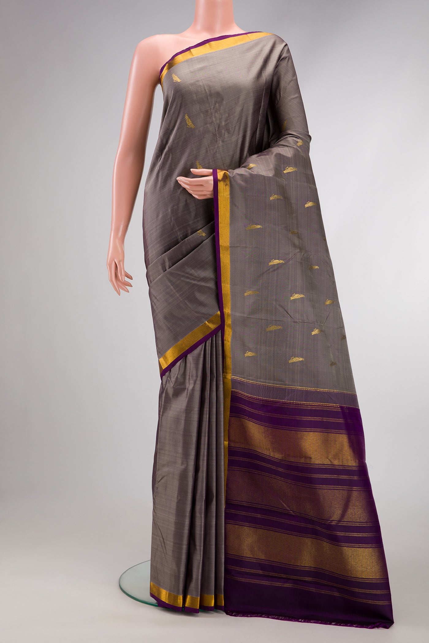 Grey Dual Tone Kanchipuram Silk Saree with Zari Butta on the body and Zari Border.  displayed on a mannequin
