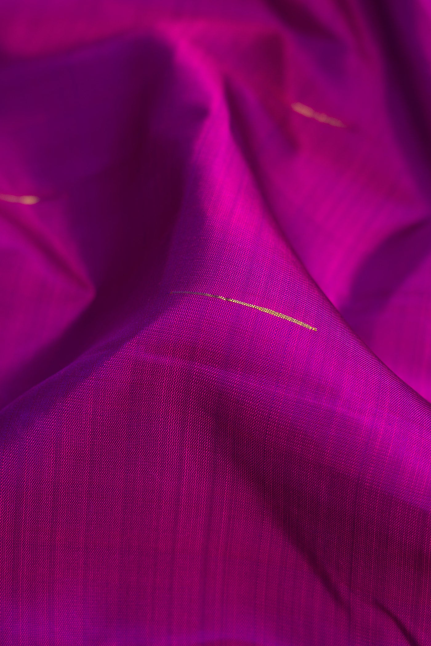 Close up of Purple Dual Tone Kanchipuram Silk Saree with Zari Butta on the body and Zari Border.  displaying folds