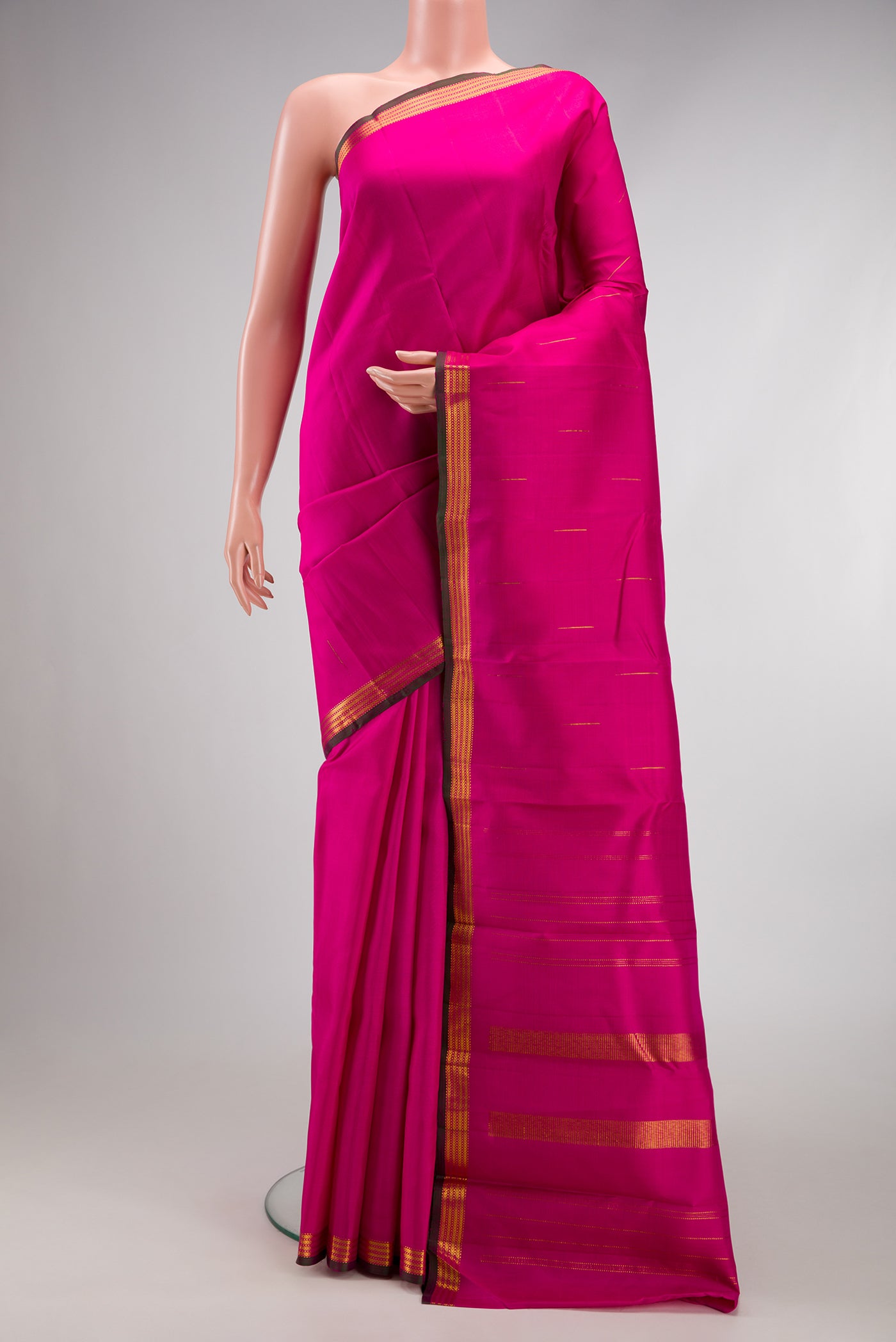 Pink Kanchipuram Silk Saree with Zari Butta on the body and Zari Border.  displayed on a mannequin