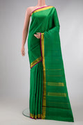 Green Kanchipuram Silk Saree with Zari Butta on the body and Zari Border.  displayed on a mannequin