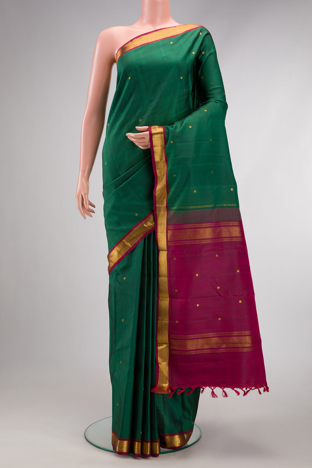 Green Dual Tone Kanjivaram Silk Saree with Zari Butta on the body and Zari Border.  displayed on a mannequin